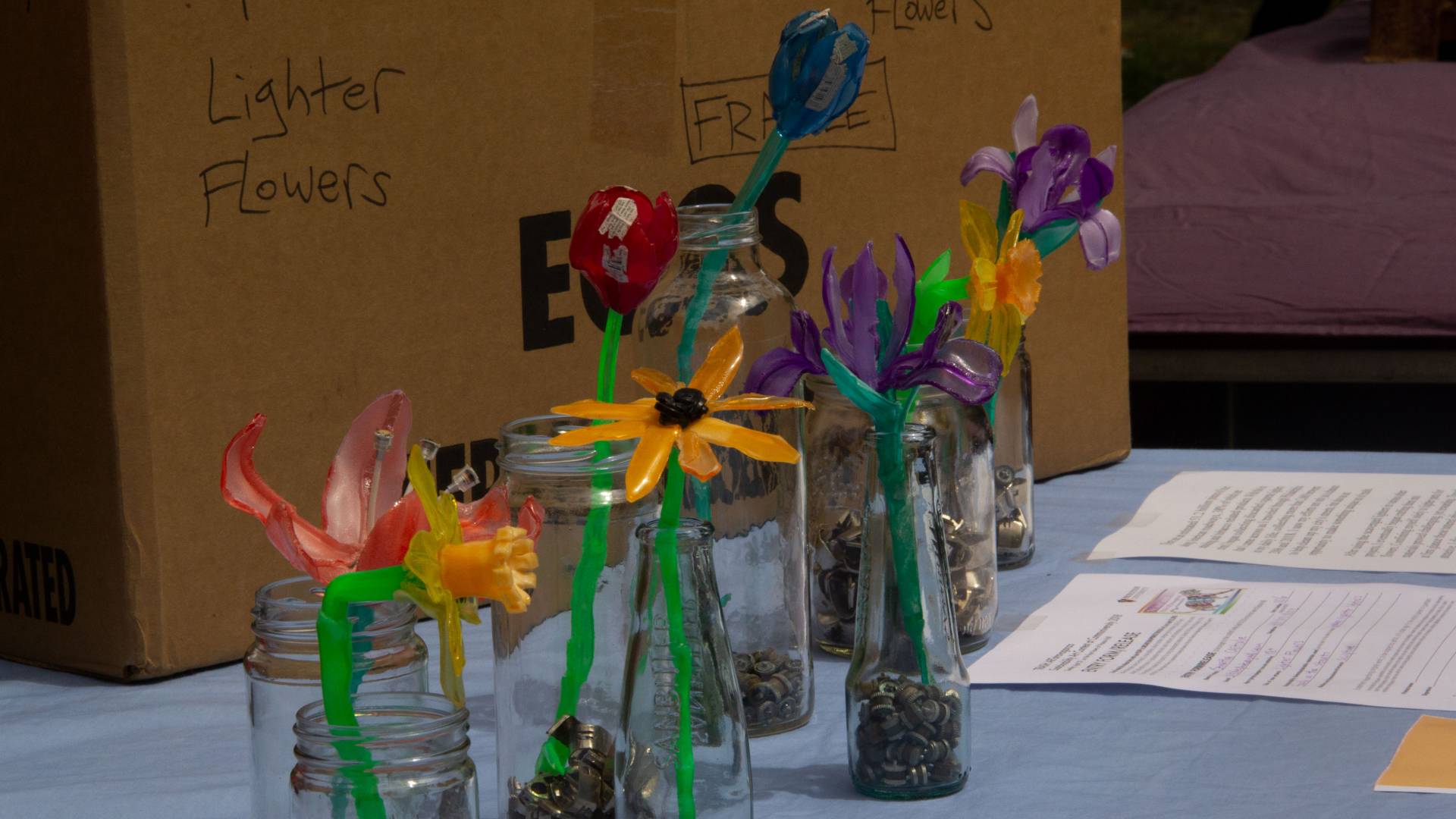 Flowers made from cigarette lighters for trash art competition