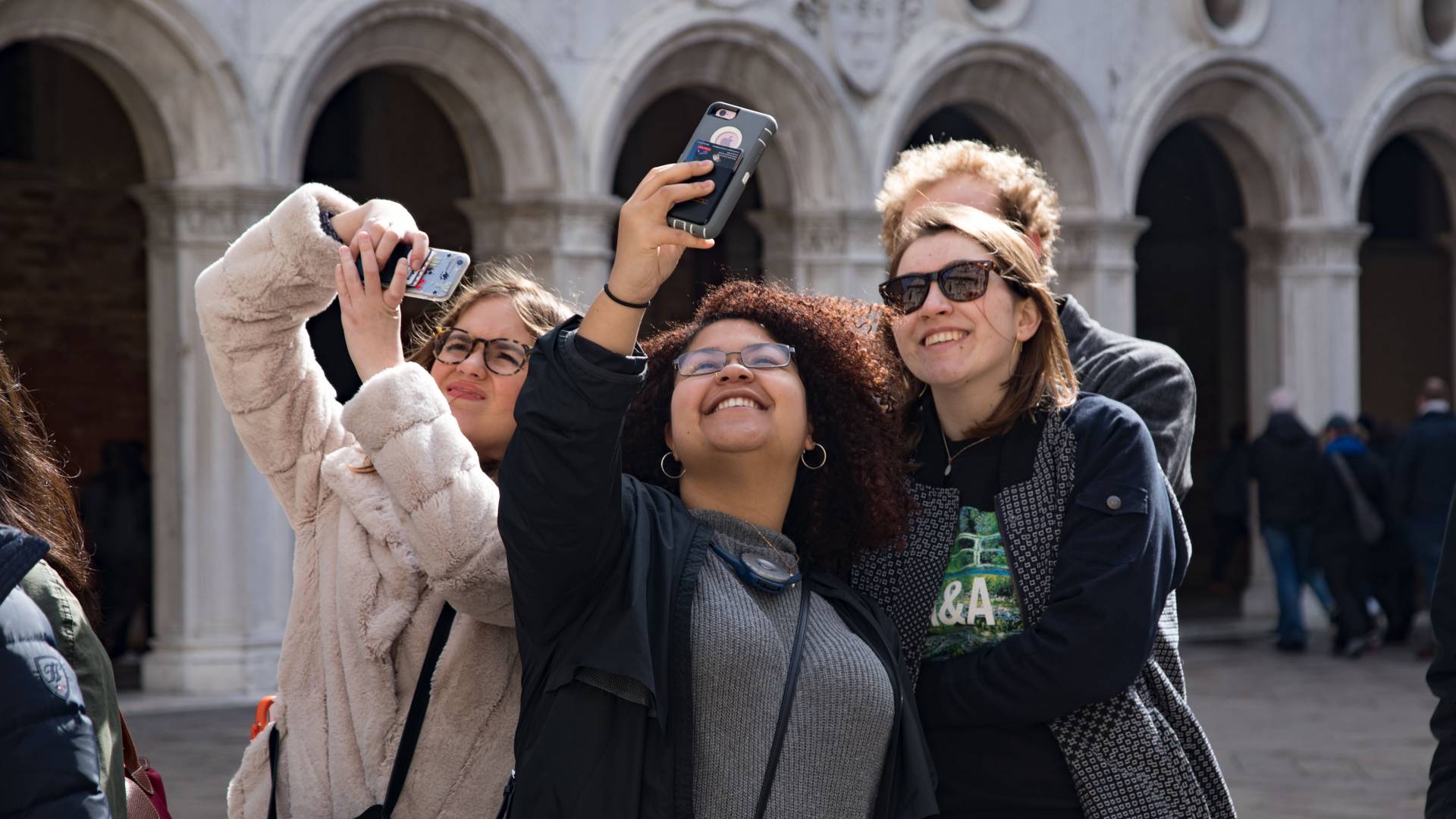 Students taking selfies outside the Doge's Palace in Venice