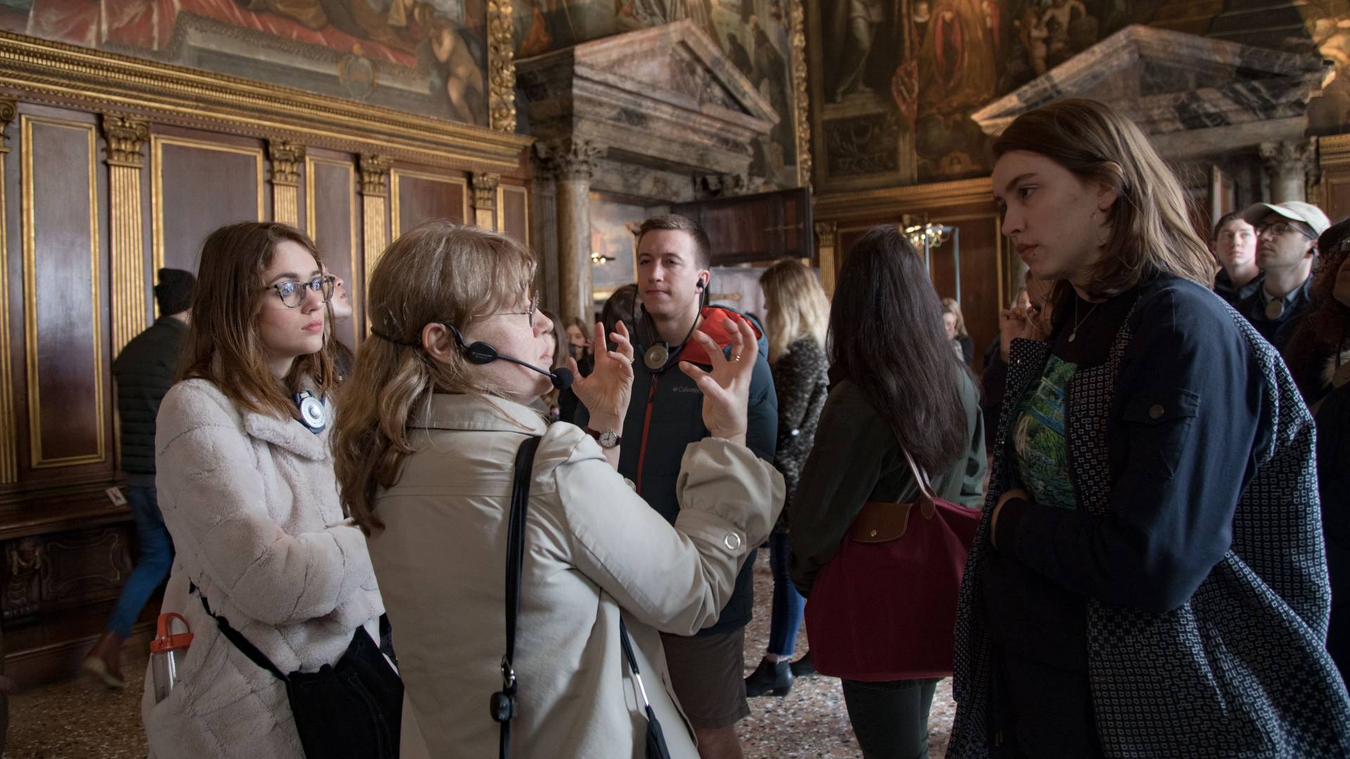 Tour guide with students inside the Doge's Palace in Venice