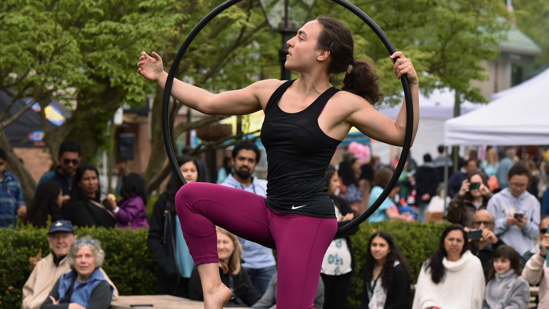 A woman performs aerial moves in a hoop