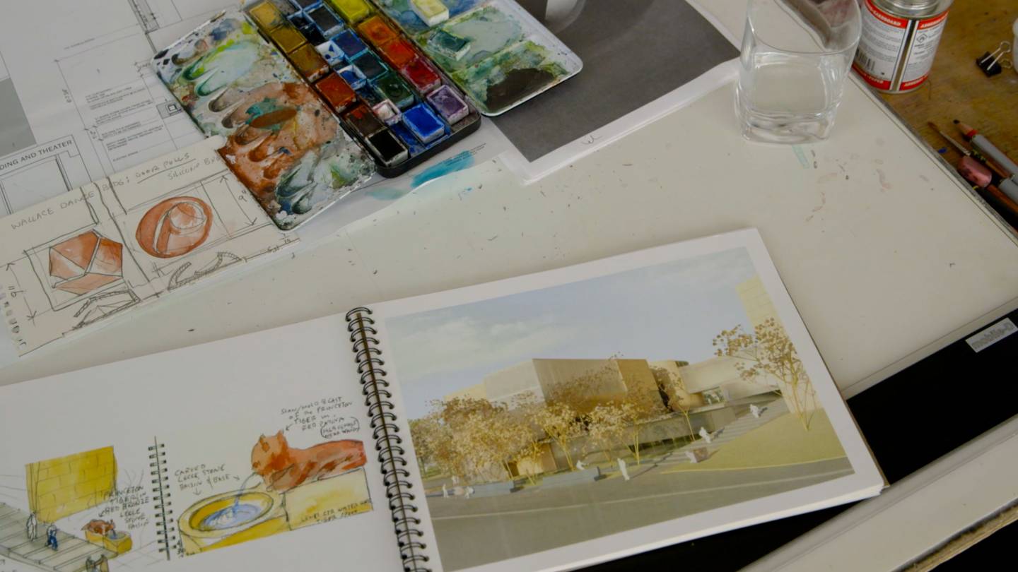 Architectural sketches, water color paints and drawings on table