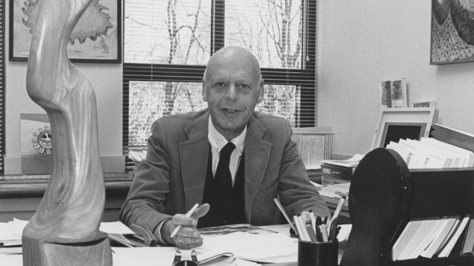 William Baumol at desk