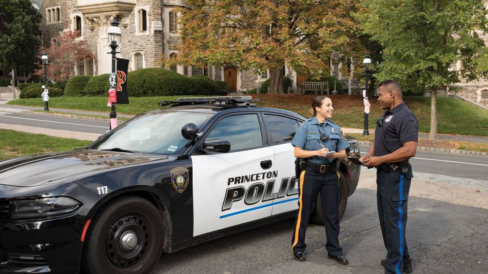 Princeton Police Department Patrol Officer Ashley Gaylord and Department of Public Safety Lieutenant David Tricoche standing by police car