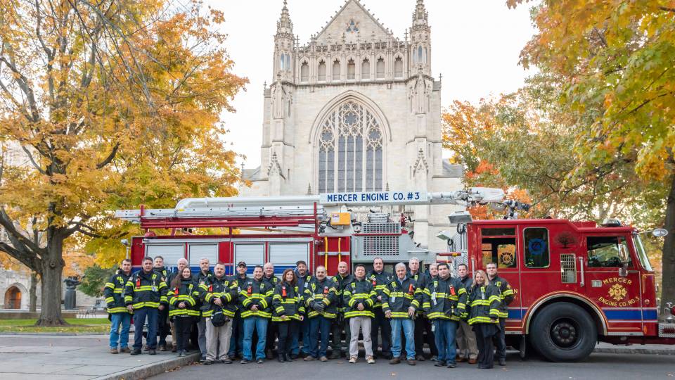 Fire engine, firefighters in front of chapel