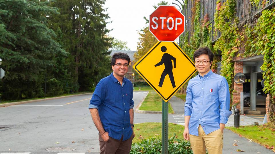 Researchers next to a stop sign