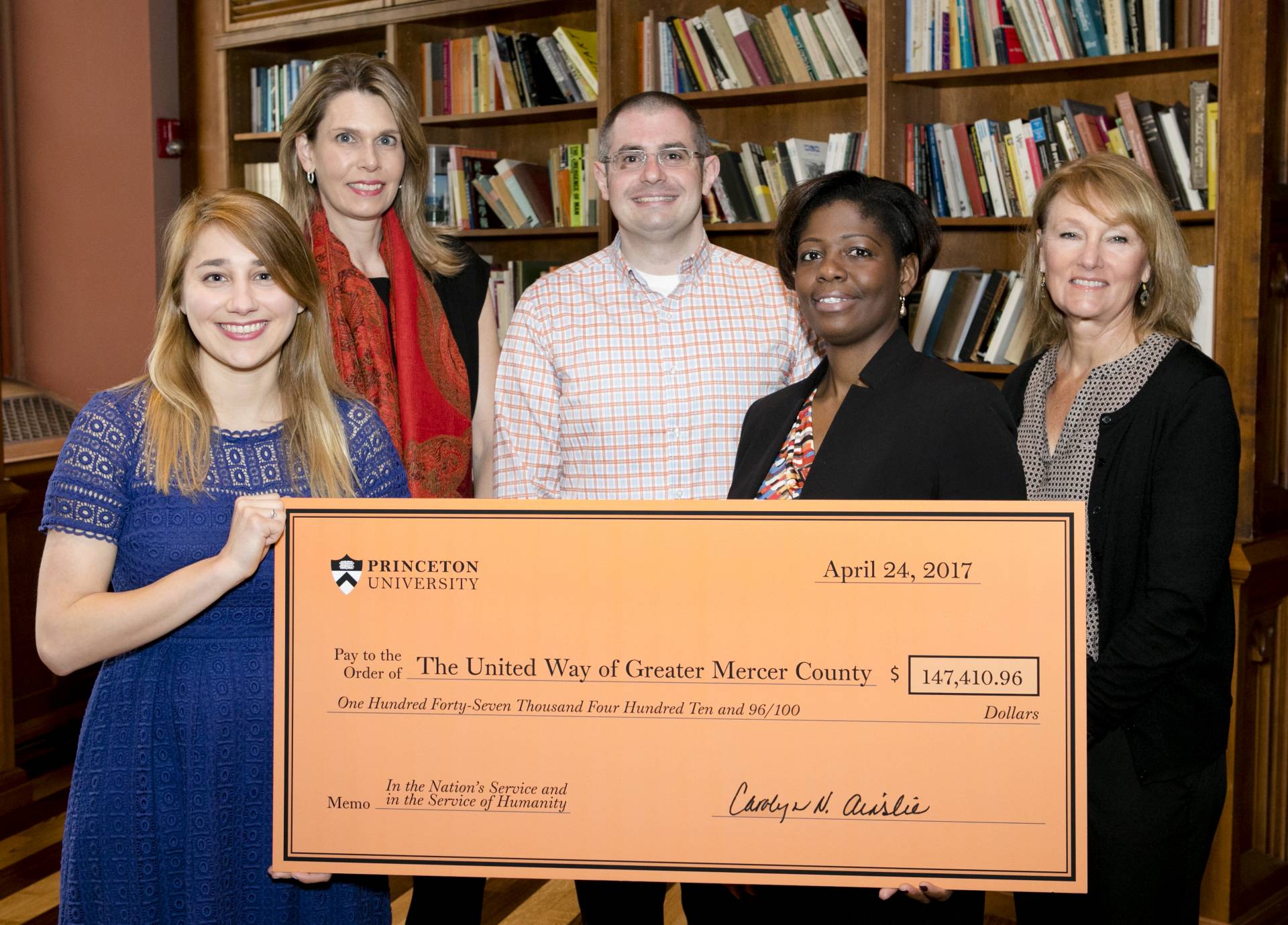 United Way and Princeton University staff holding donation check