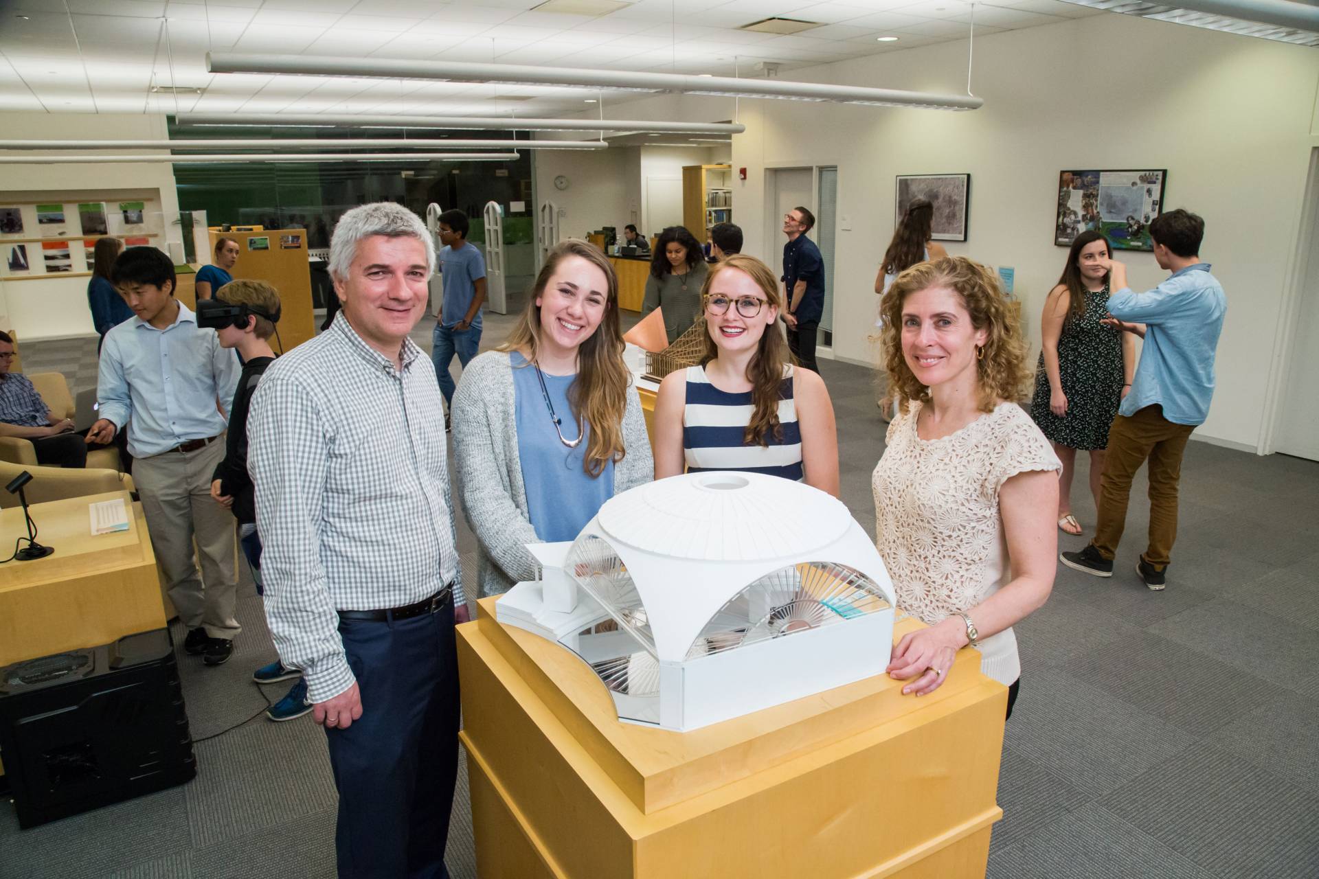 Isabella Douglas standing with architecture model and professors