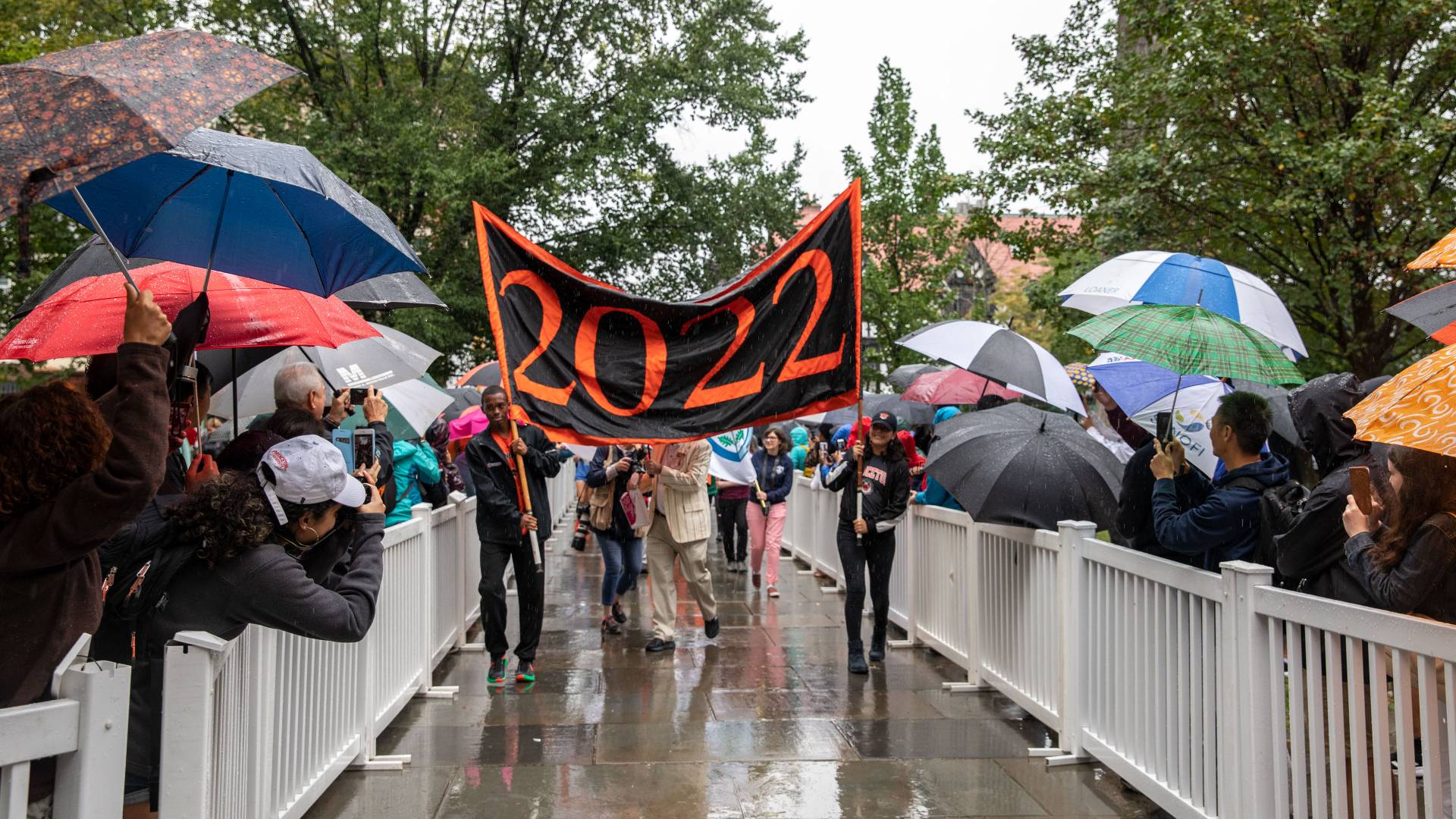 Students carrying Class of 2022 banner through Pre-rade