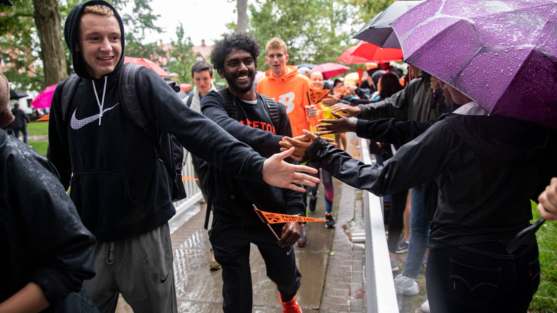 Students high-fiveing during Pre-rade