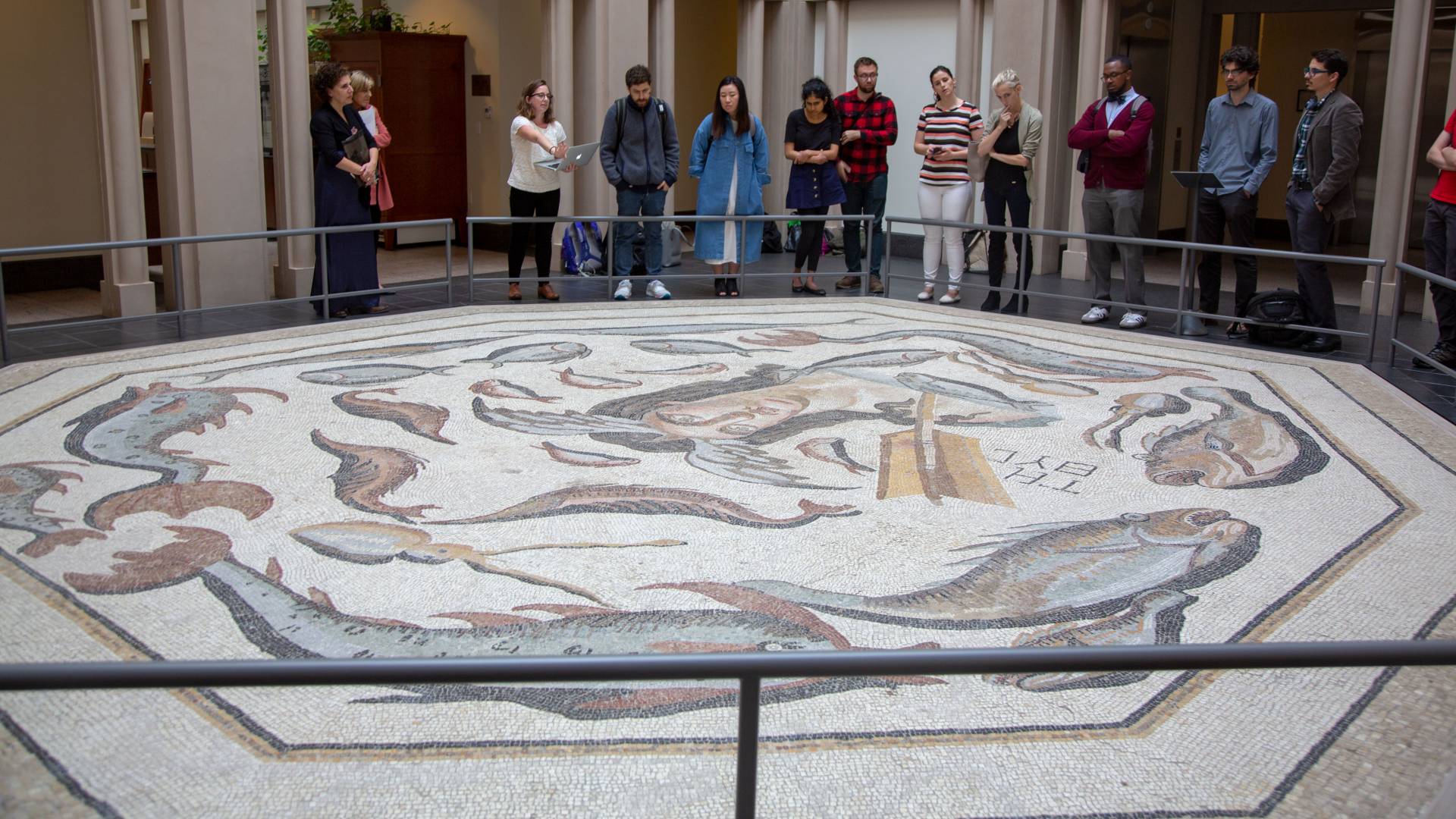 Students looking at large mosaic at Harvard museum