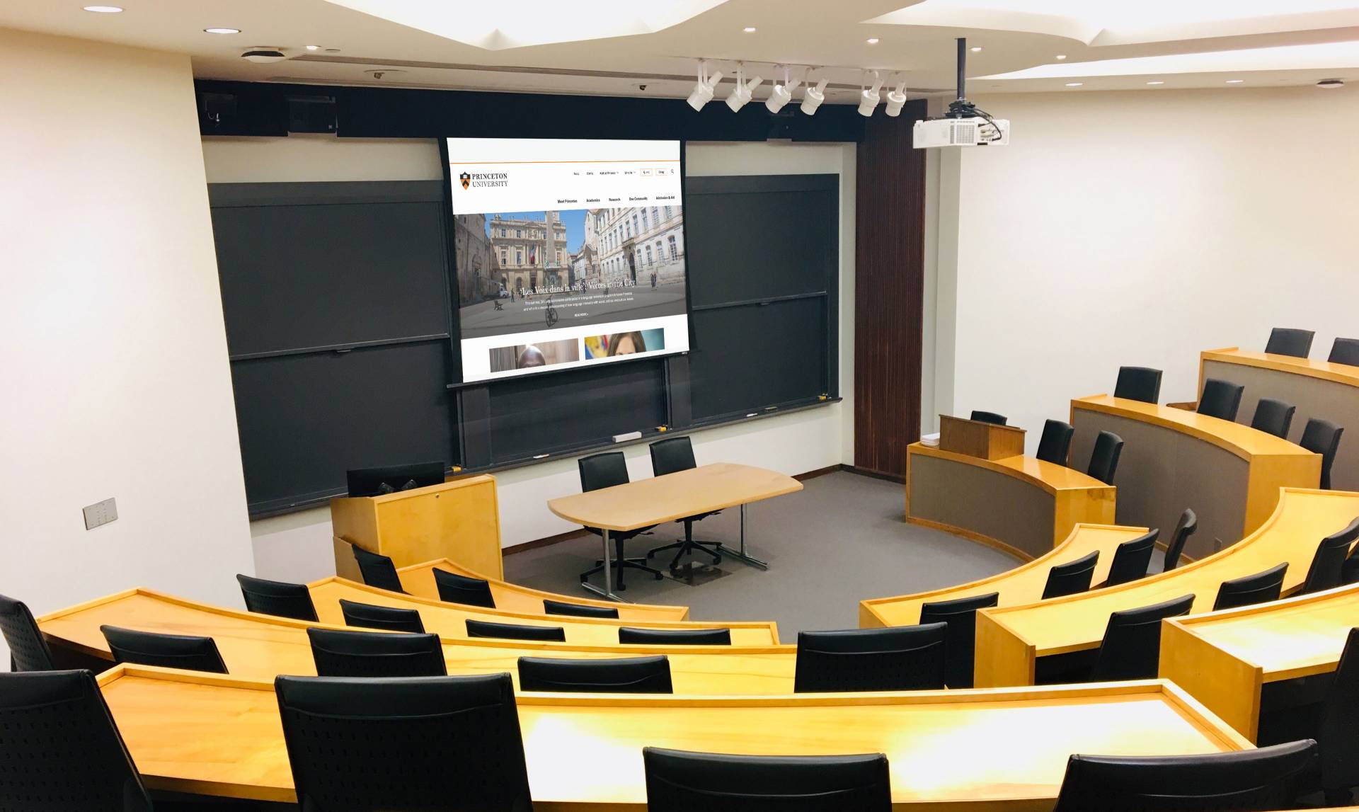 Large empty classroom with projector screen