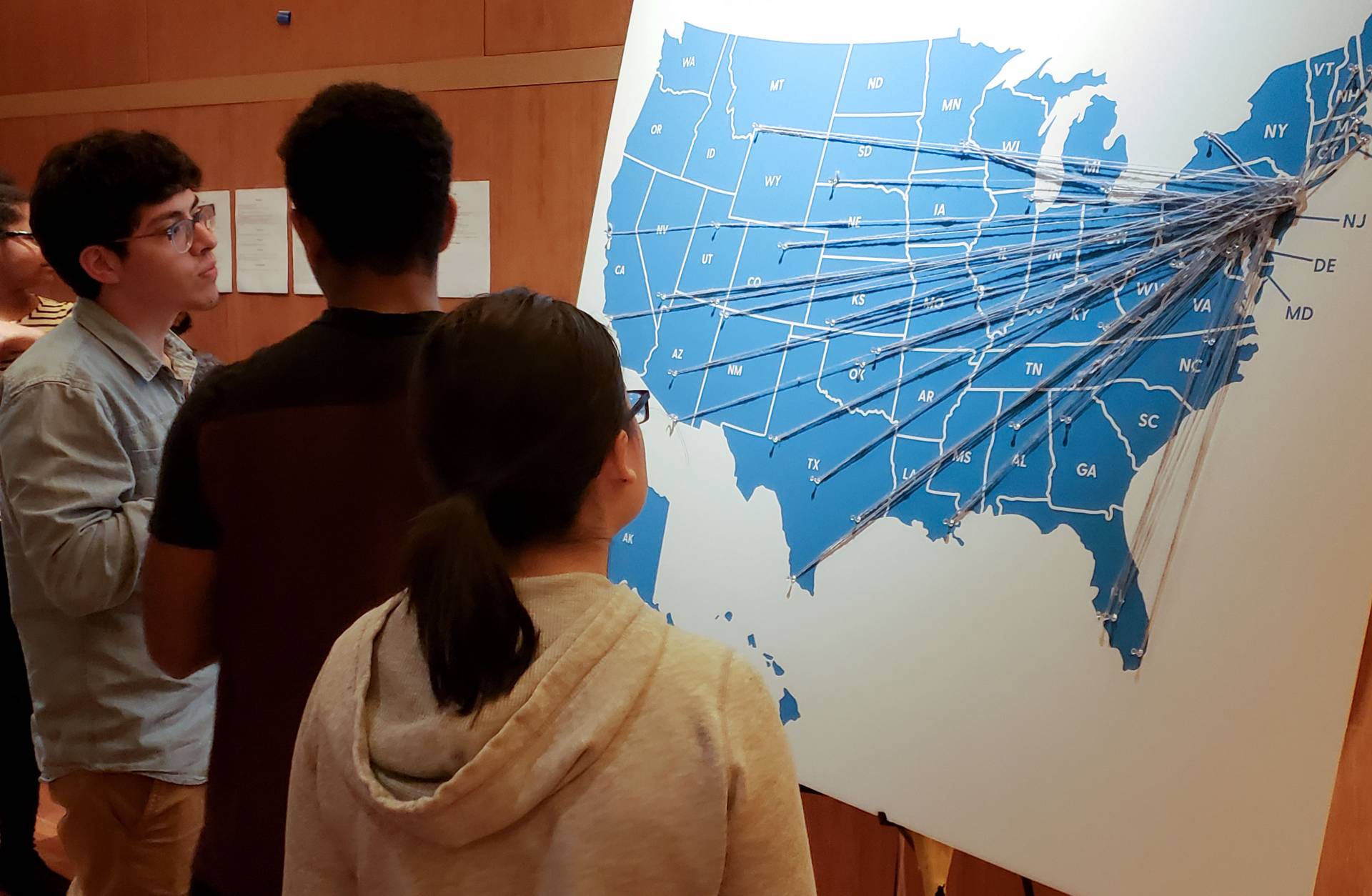 Students looking at map of US with strings and pins marking Breakout Princeton trip locations