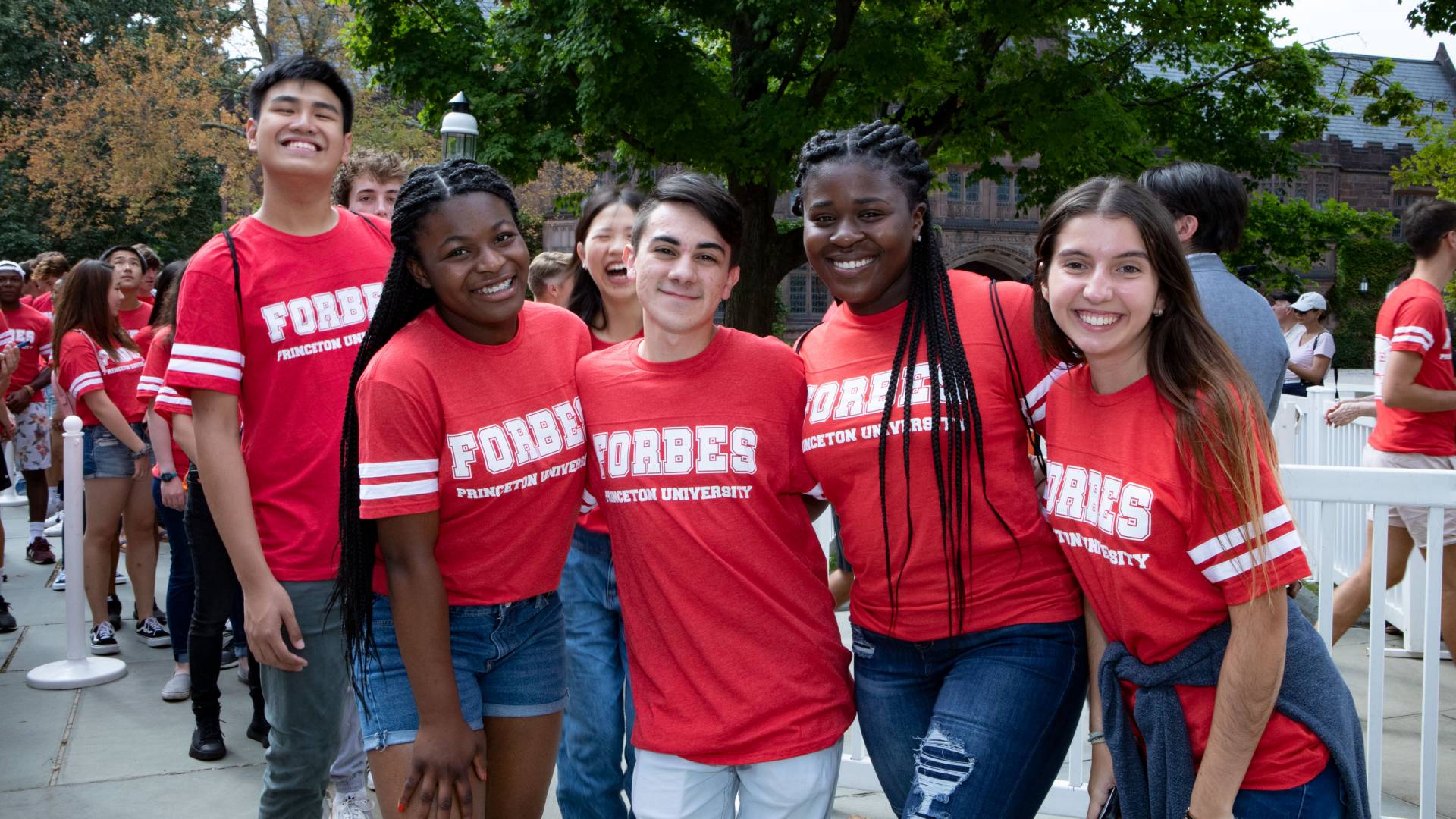 Students wearing Forbes t shirts pose for a photo