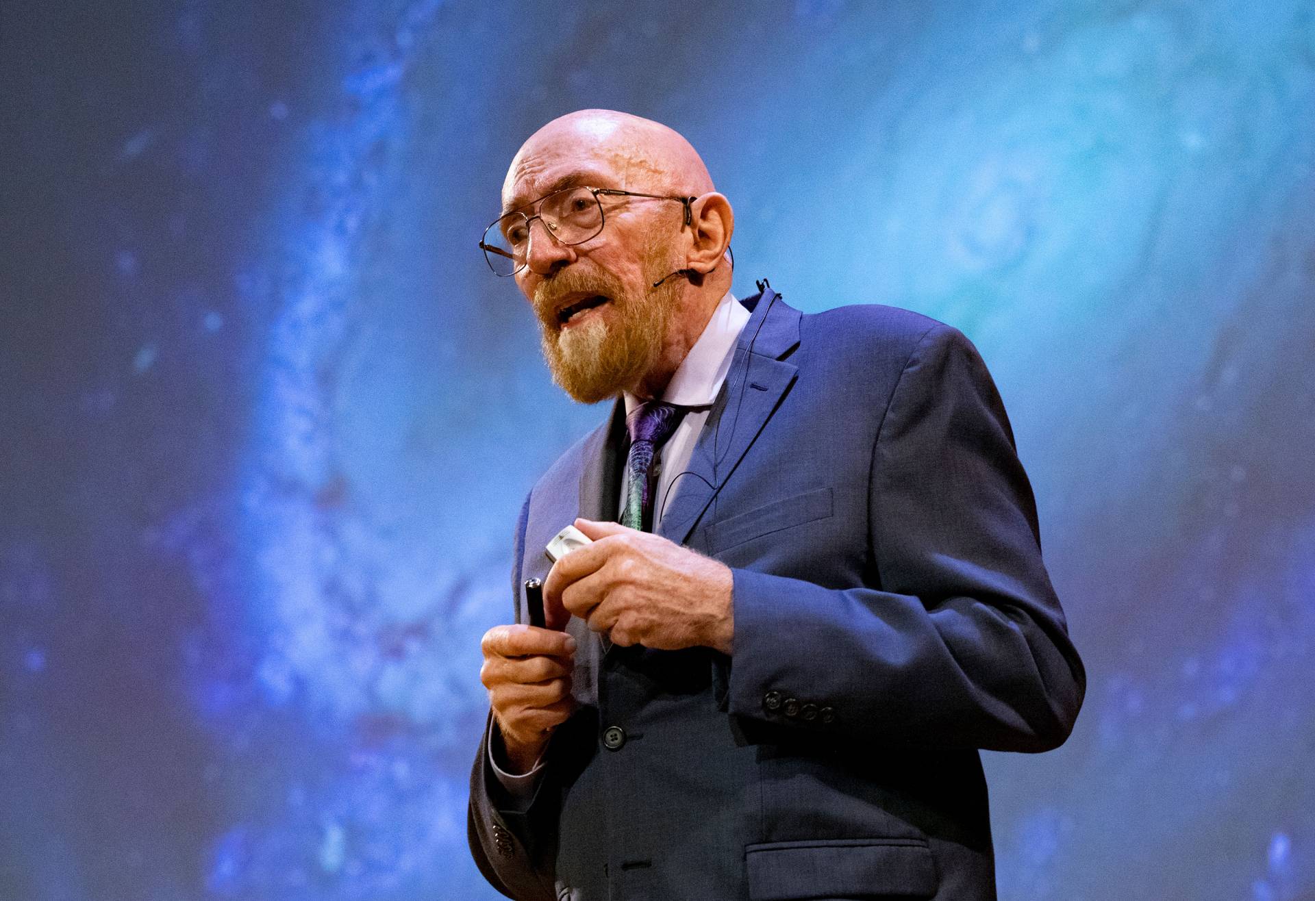 Kip Thorne in front of a projected image of the Milky Way