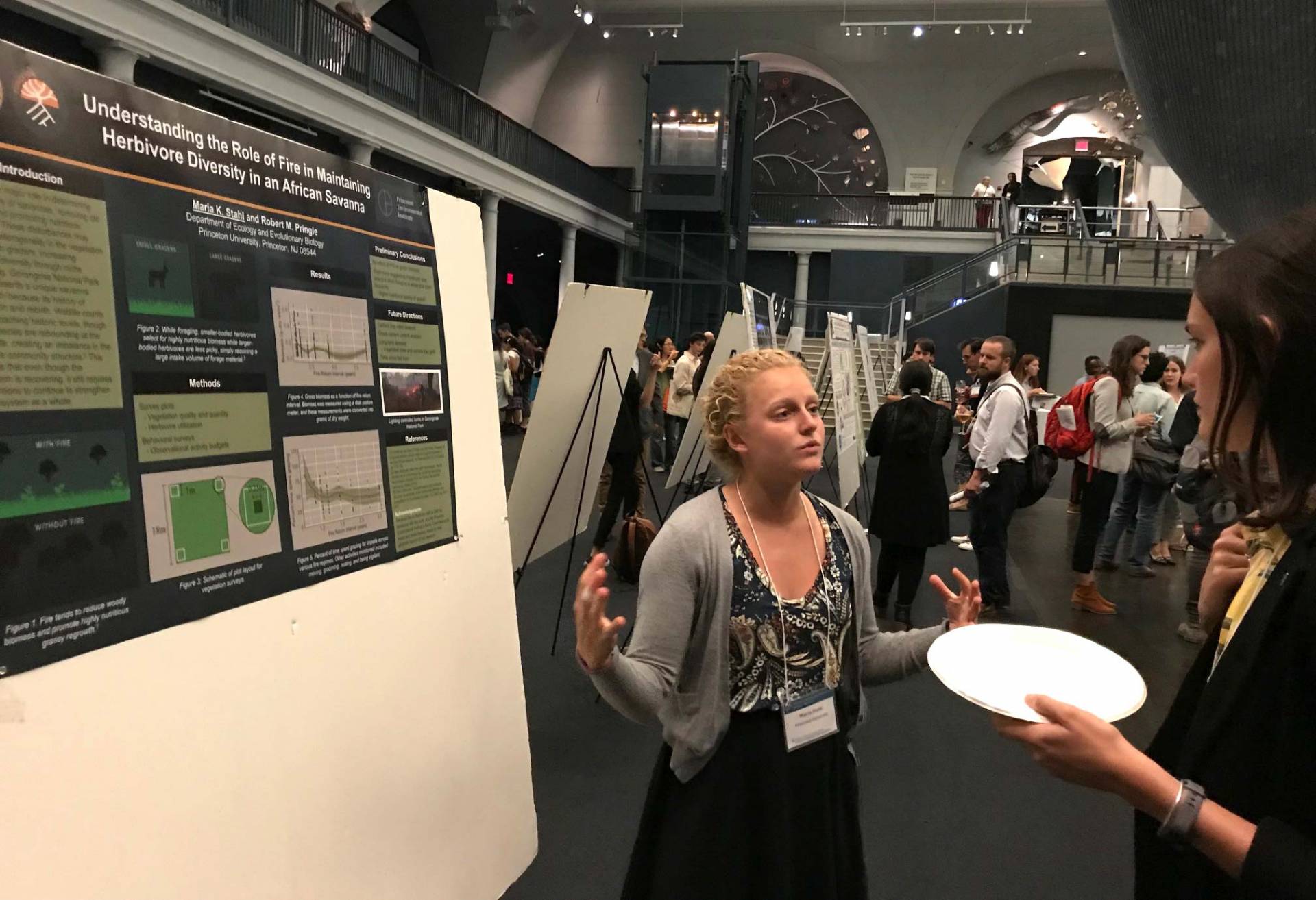Stahl presents her research in front of her poster