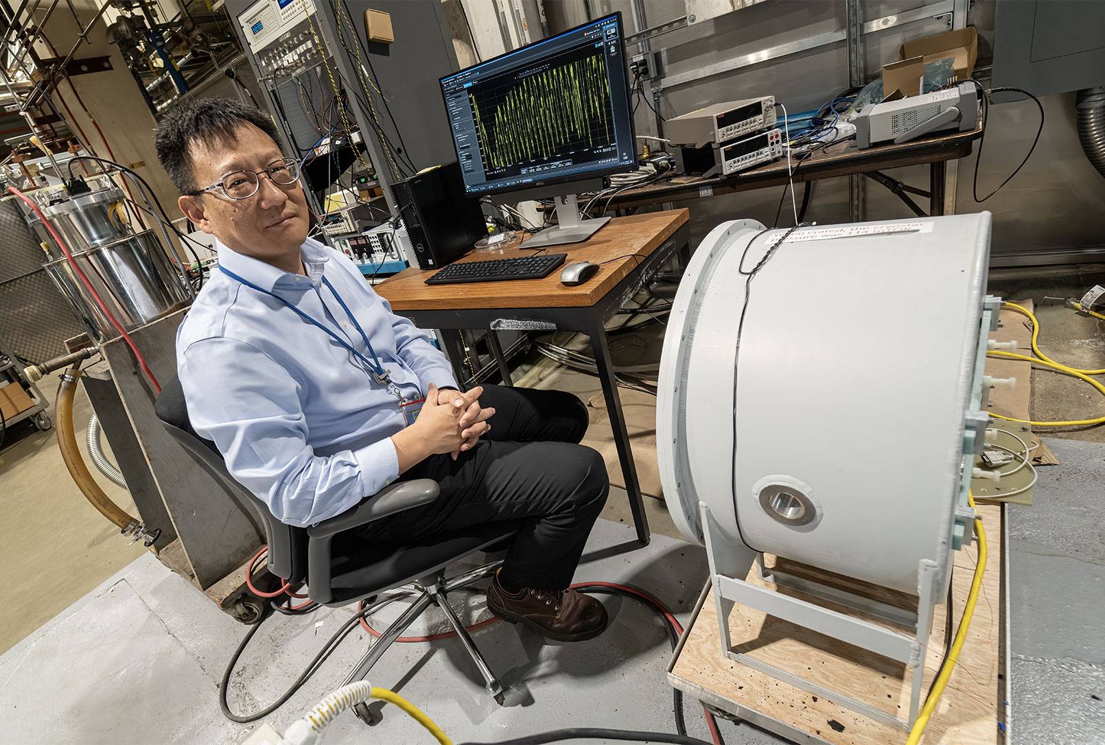 Yuhu Zhai in his lab surrounded by equipment