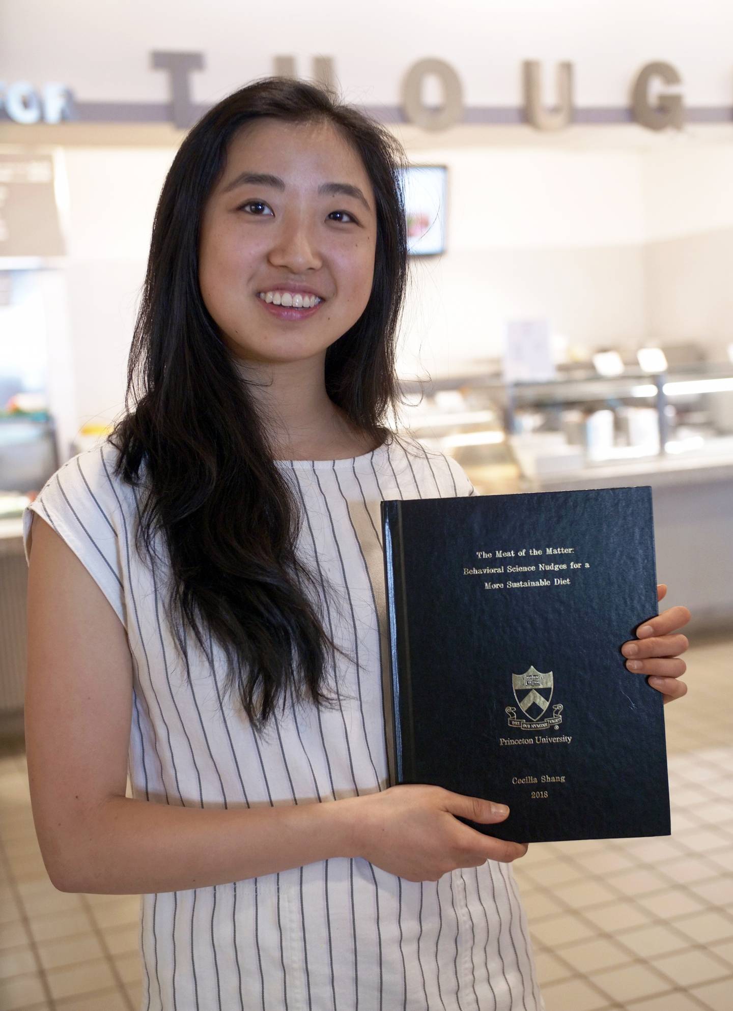 Cecilia Shang with her thesis