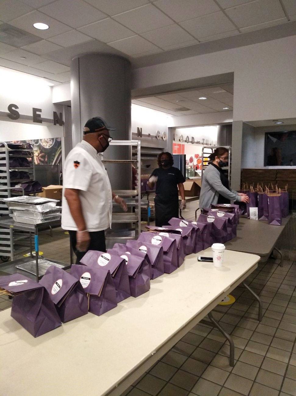 Campus Dining workers line up packages of food to be delivered