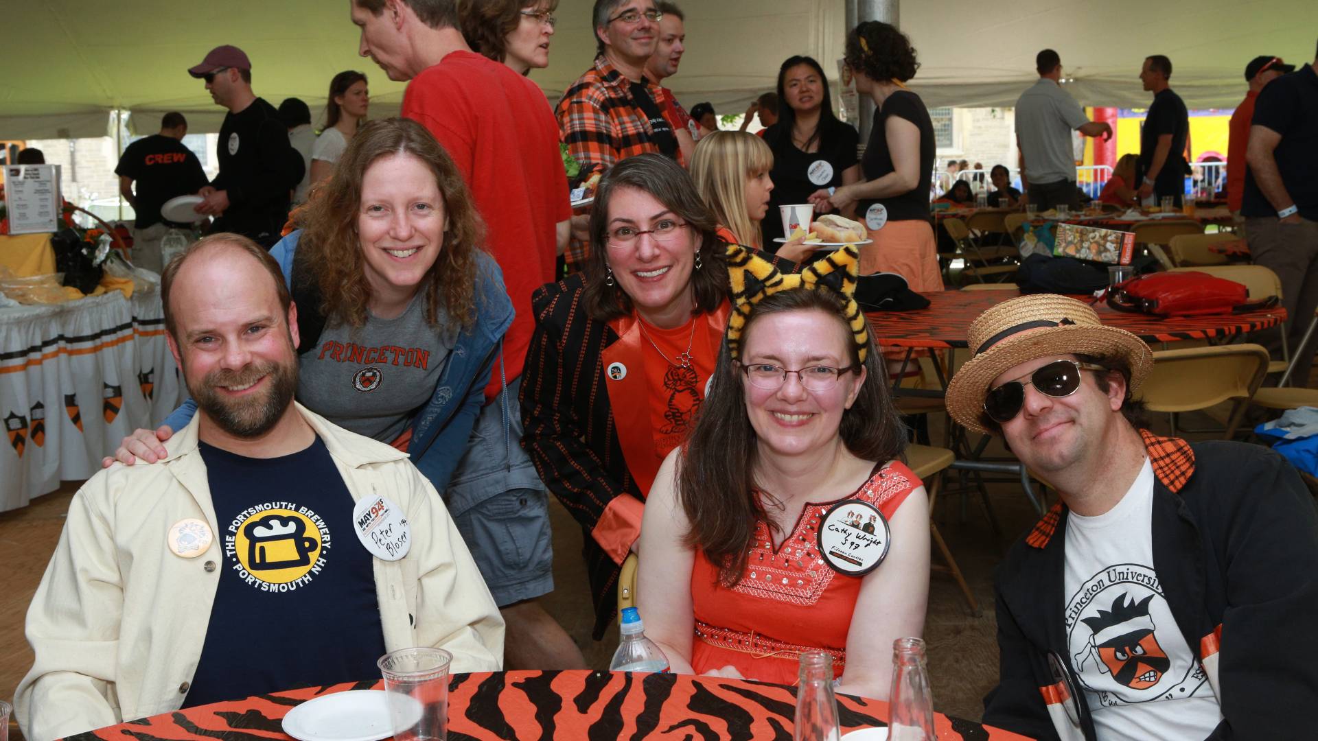 Photo of friends and families at reunions posing at table