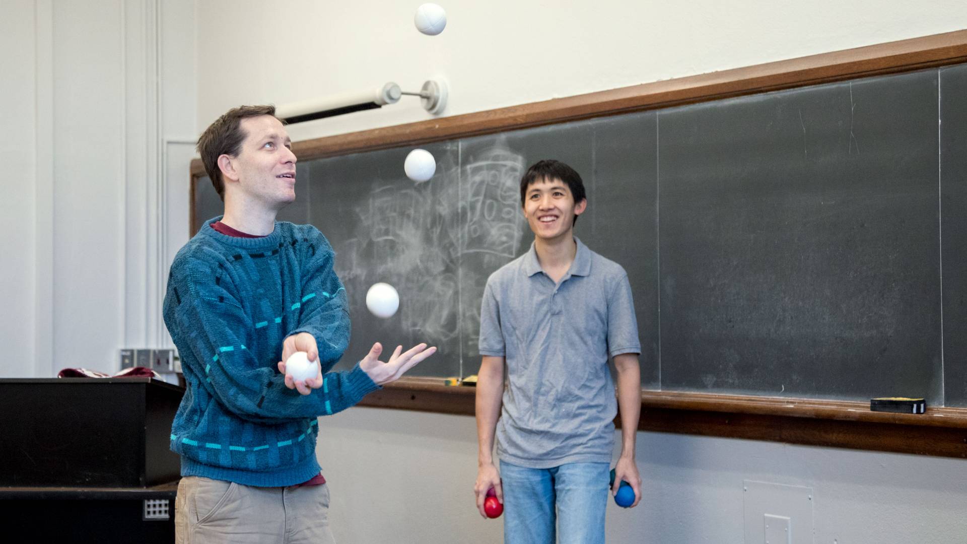 Students juggling in classroom