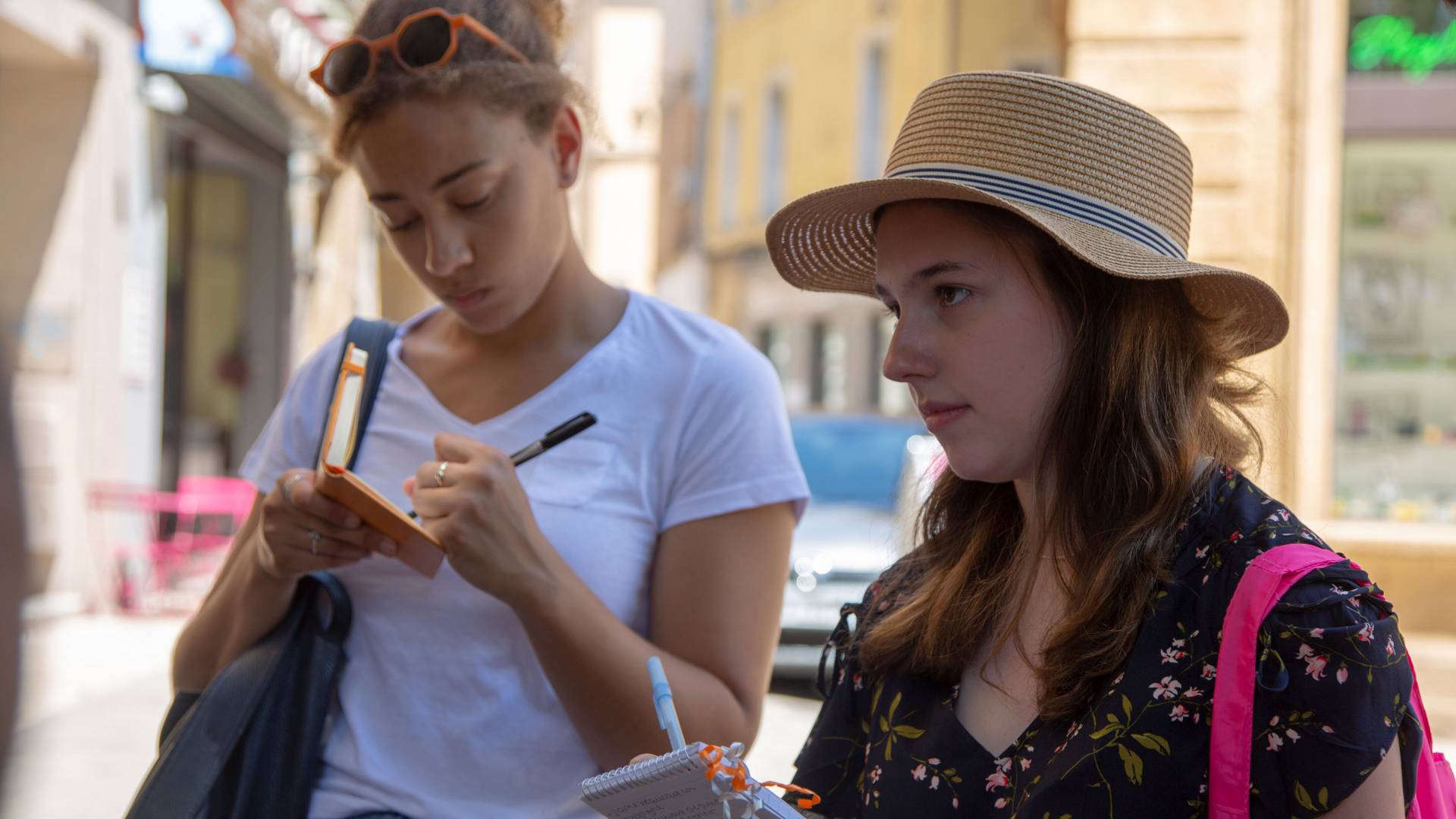 Two students taking notes in France