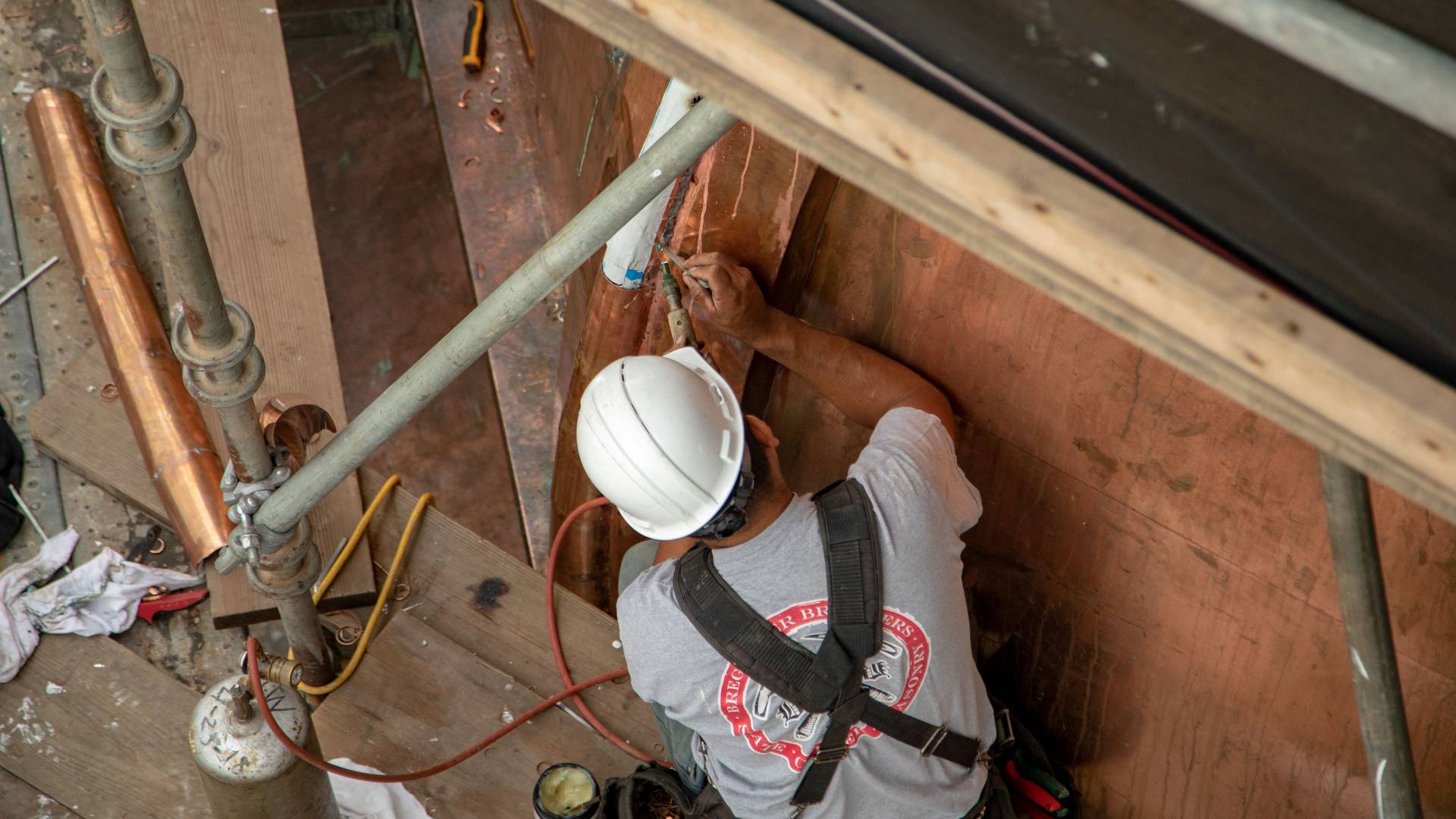 Worker soldering part of Nassau Hall cupola