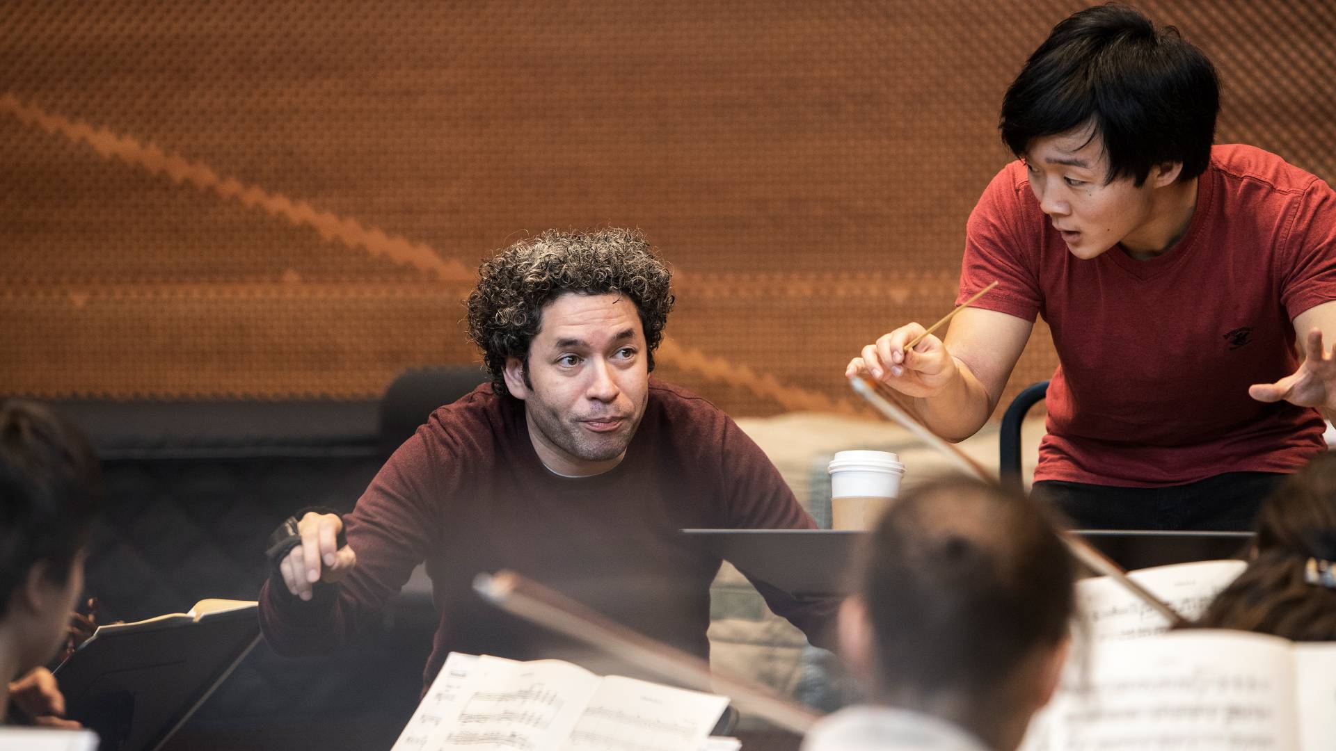Gustavo Dudamel and Lou Chen conducting orchestra