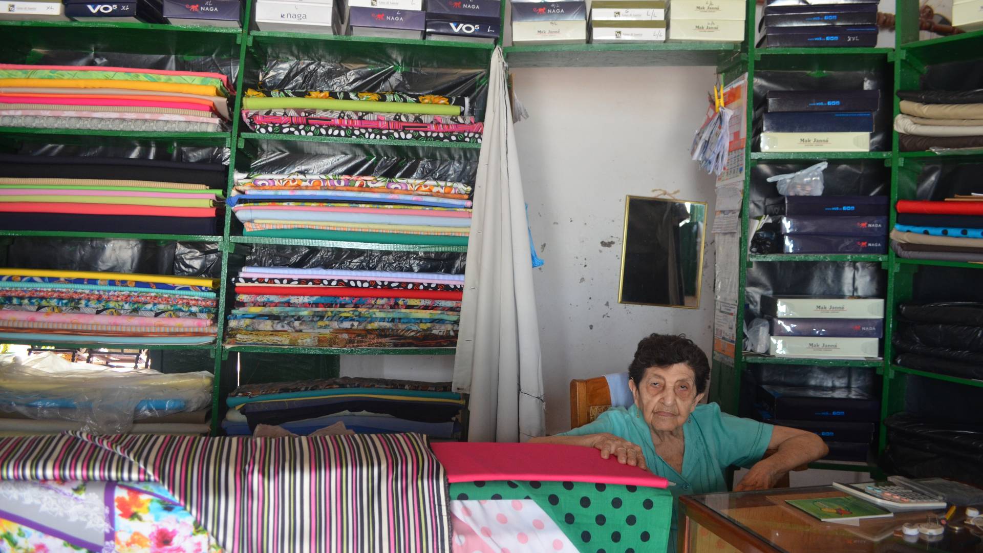 Woman sitting in fabric shop