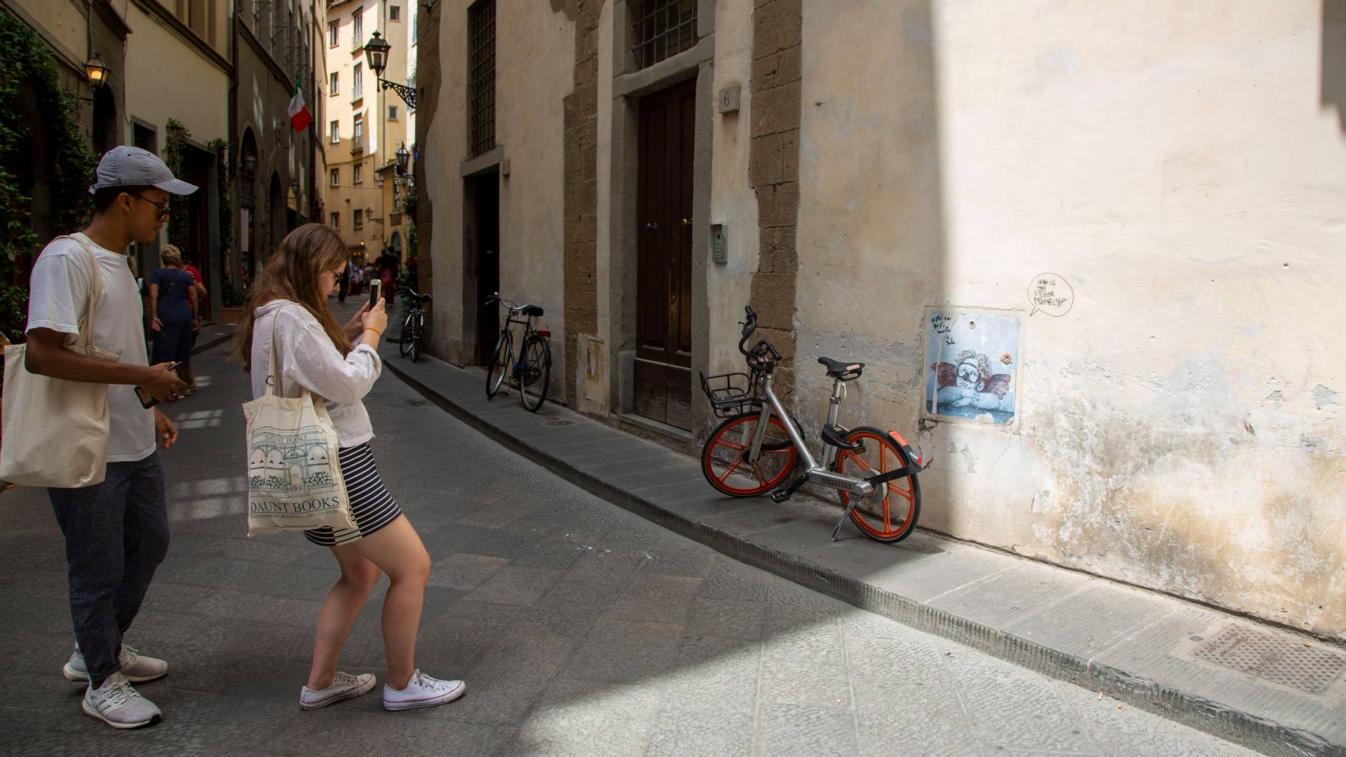 Students take photos of graffiti in Florence
