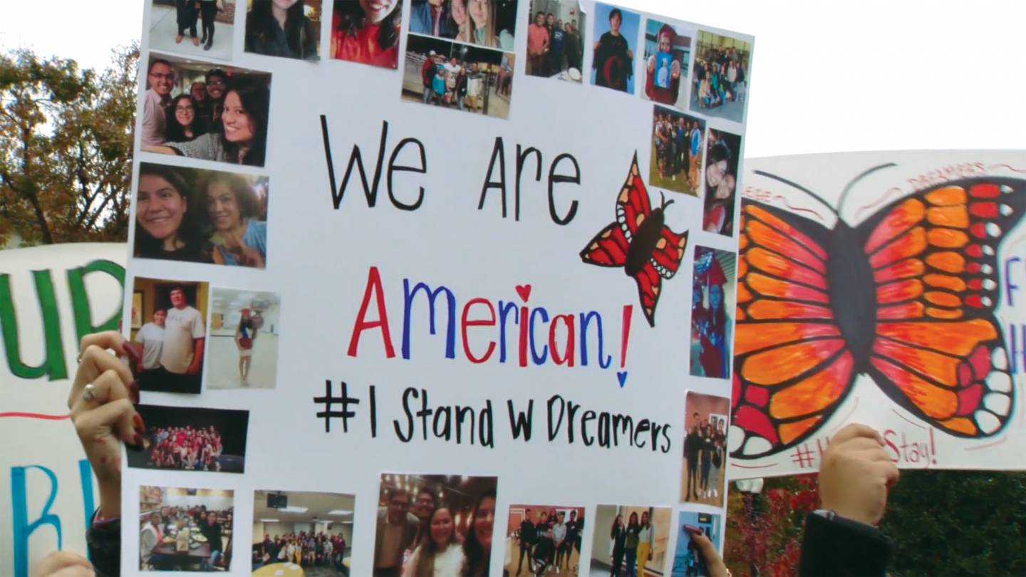 protest sign reading, "We are American. #IStandwDreamers"