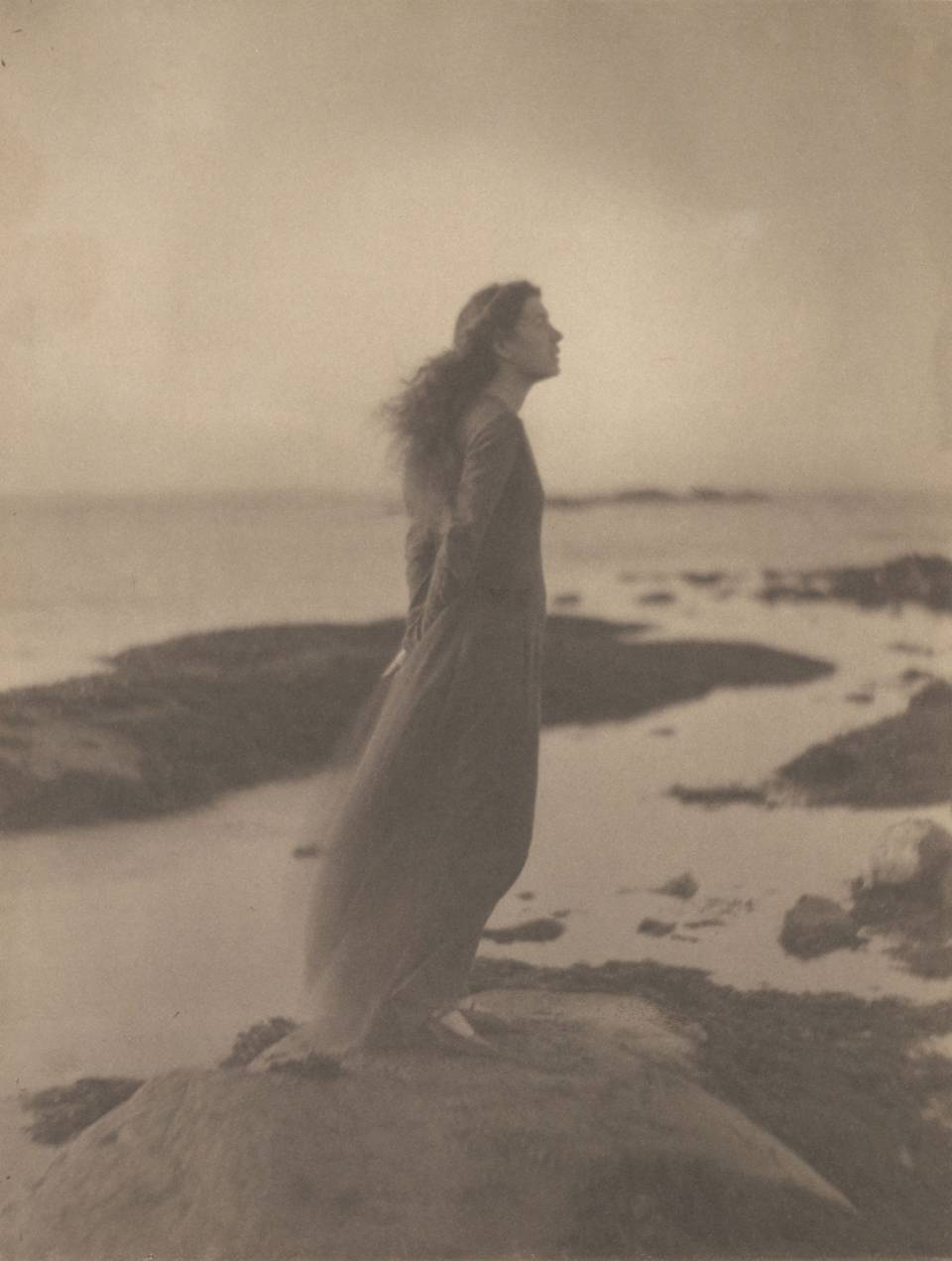 Woman standing by the sea
