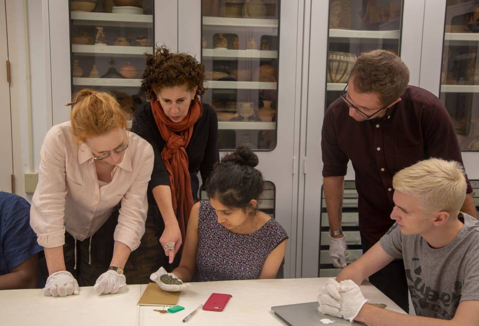 Faculty and students looking at ancient artifacts at Art Museum
