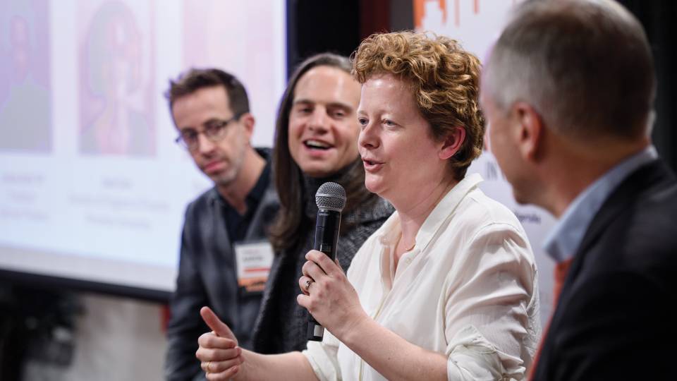 Jane Cox speaks into a microphone at TigerTalks 2018