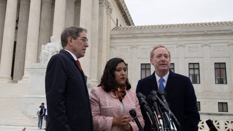 Christopher Eisgruber, Brad Smith and Maria Perales Sánchez on the steps of the Supreme Court building in Washington, D.C.