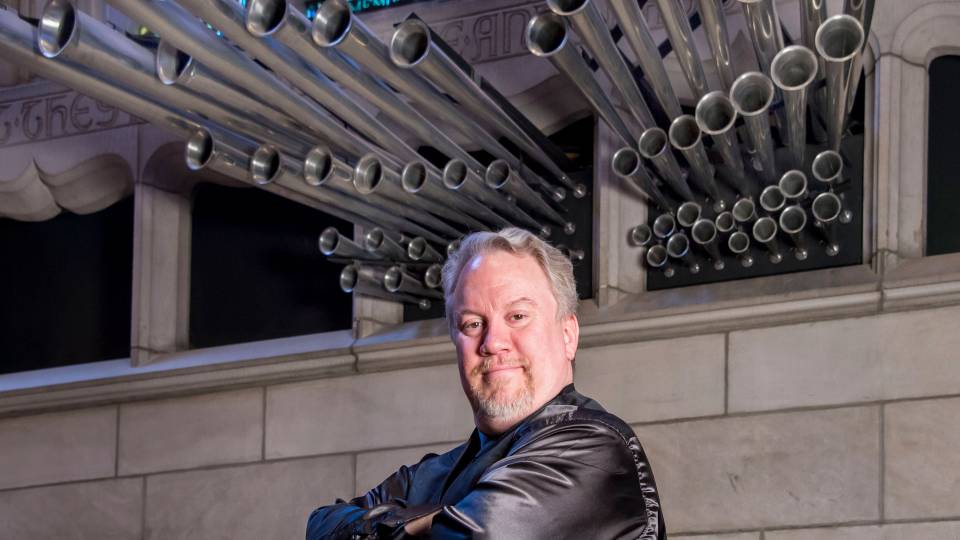 Eric Plutz in front of organ pipes