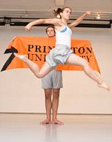 dancer jumping in front of Princeton banner
