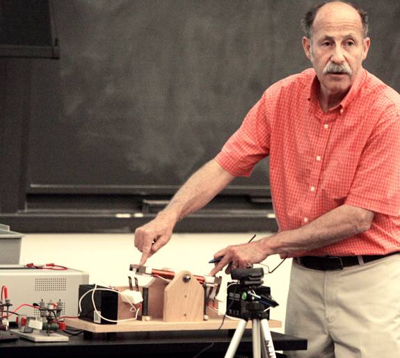 Professor Littman points to each end of a lever