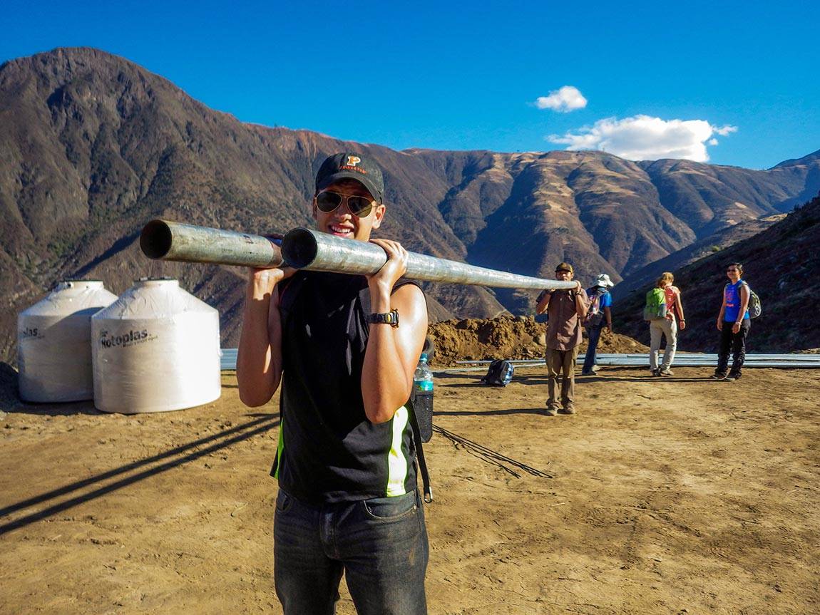 Engineers Without Borders students: In one EWB project, Will Guiracoche, now a junior, helped carry pipes up a mountain to install a system for delivering fresh water to the town of La Pitajaya in the summer of 2014.