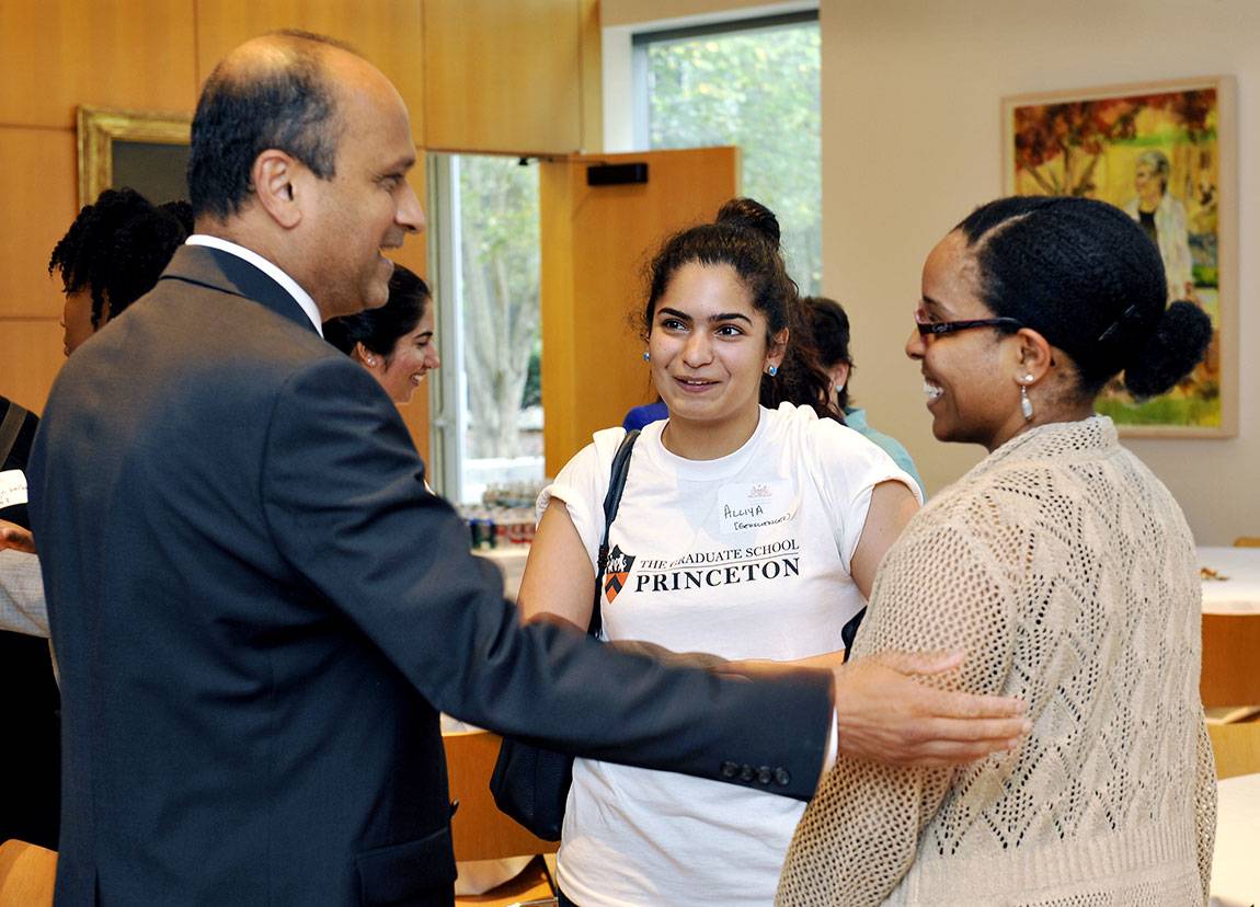 Kulkarni greets Alliya Akhtar, center, a fourth-year doctoral student in geosciences, and Sonja Francis, a lecturer in chemistry