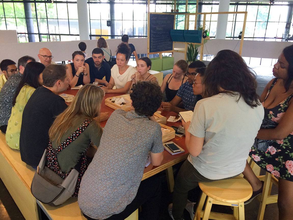 Sitting inside of the 32nd São Paulo Bienal with head curator Jochen Volz (seated on left bench, in black shirt)