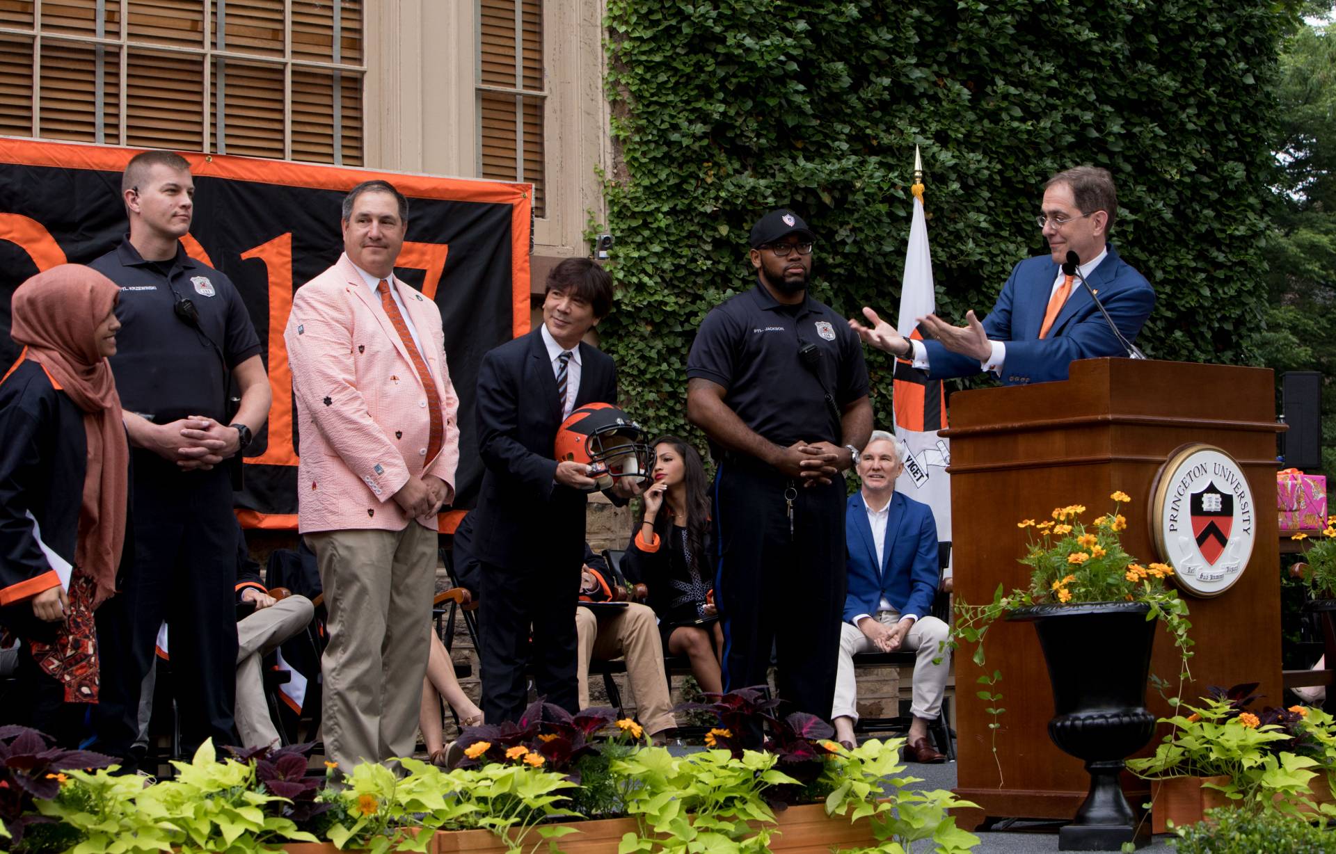 President Eisgruber presenting football helmut to students at Class Day 2017 ceremony