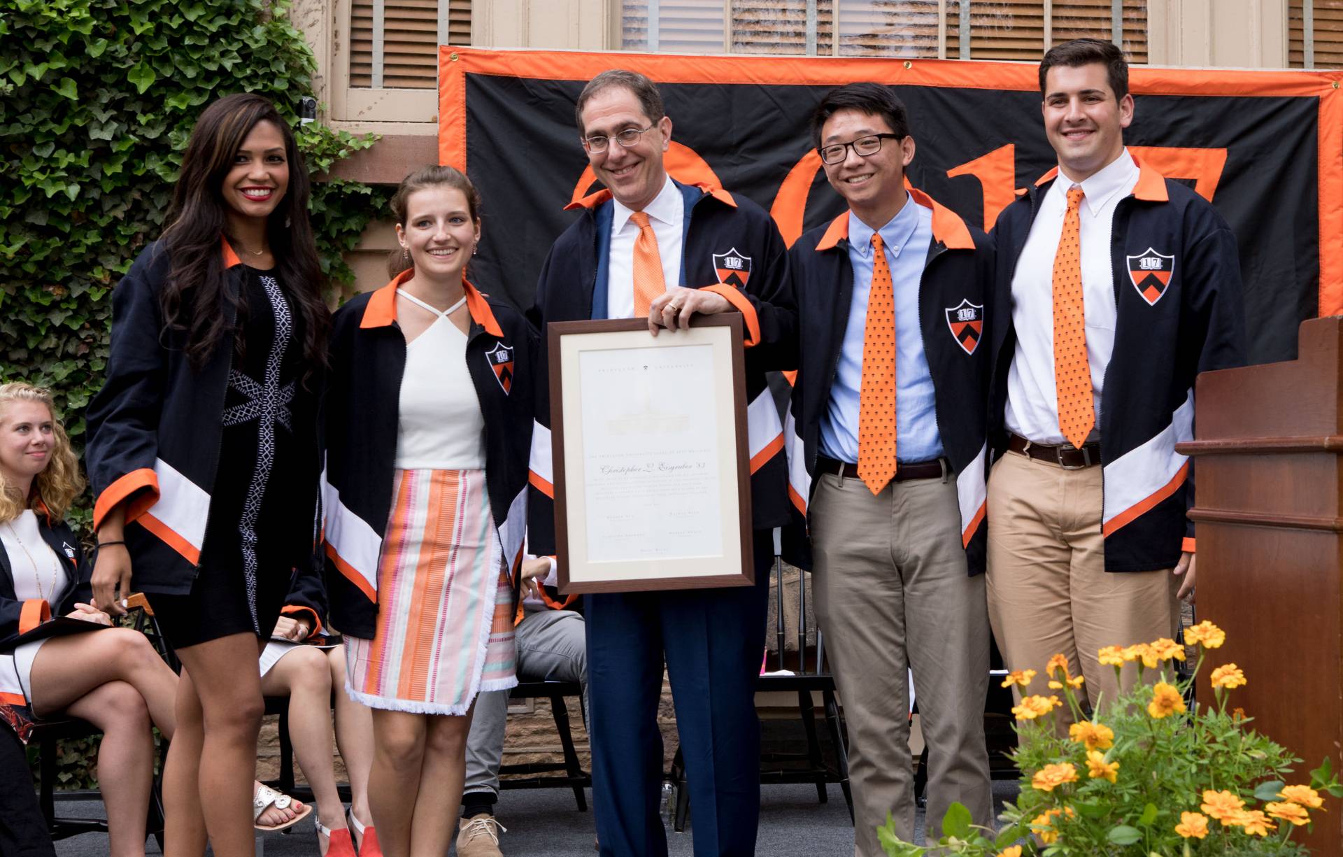 President Eisgruber standing with students after receiving Class Day 2017 jacket