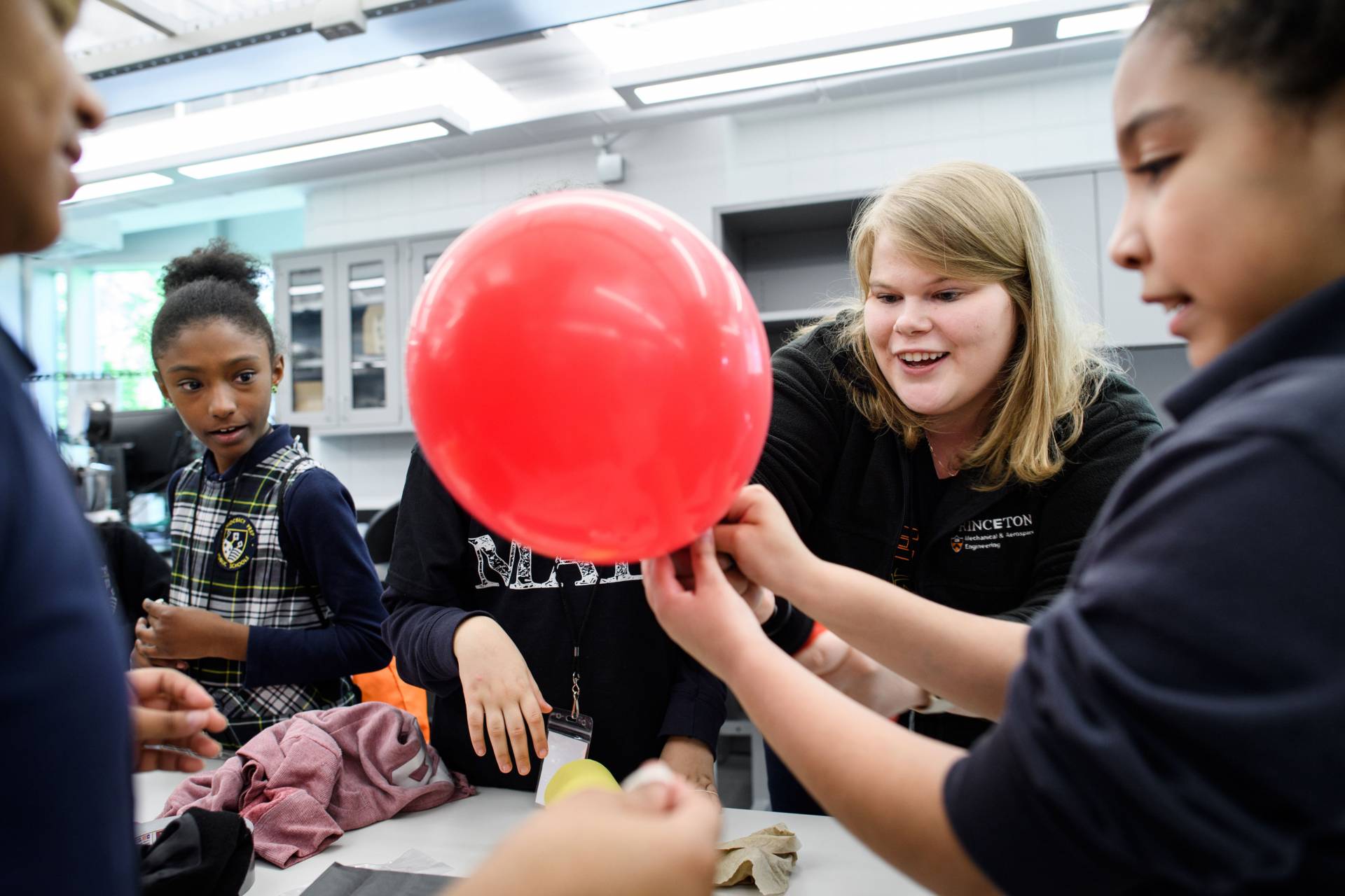 Harlem Prep students with graduate student Sarah Gady and balloons