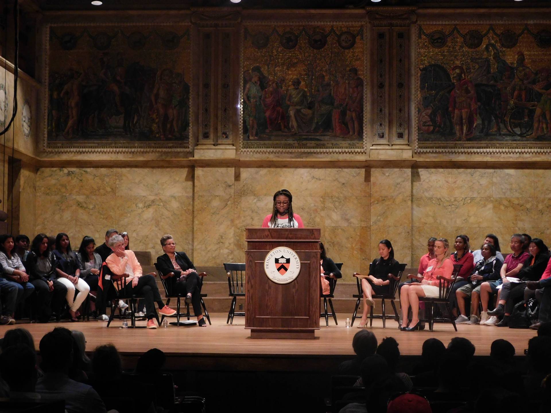 Myesha Jemison speaks to an audience family members during the Orientation welcoming program at Richardson Auditorium. 