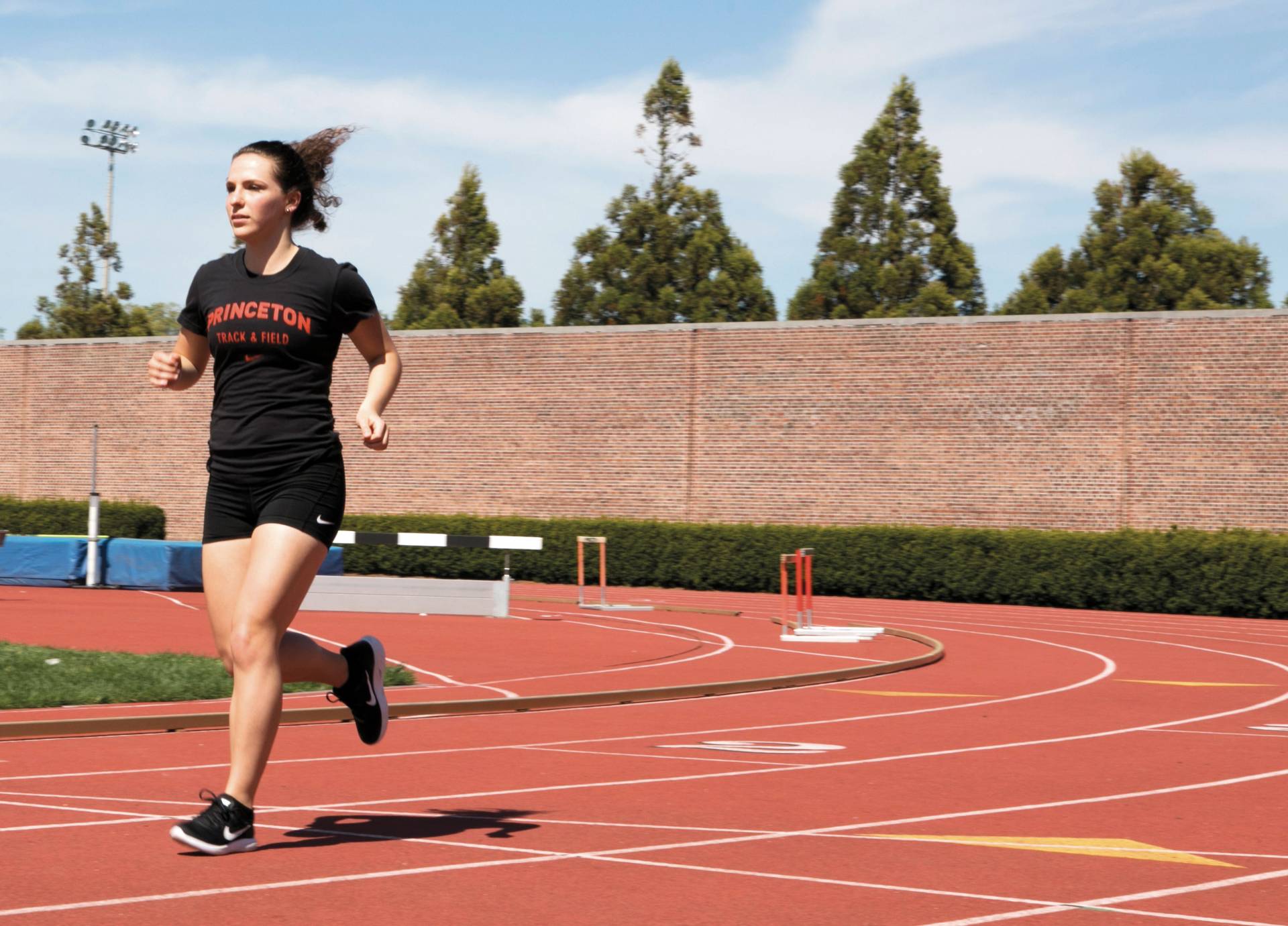 Melana Hammel running on outside track