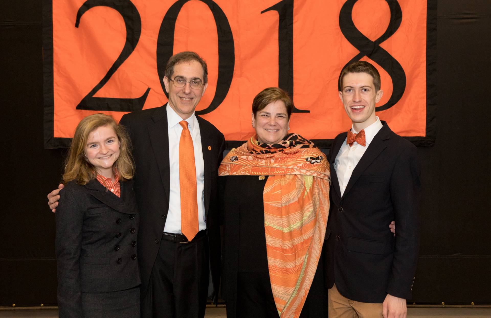 Pyne Prize winners stand in front of 2018 banner with Kathryn Hall and President Christopher L. Eisgruber
