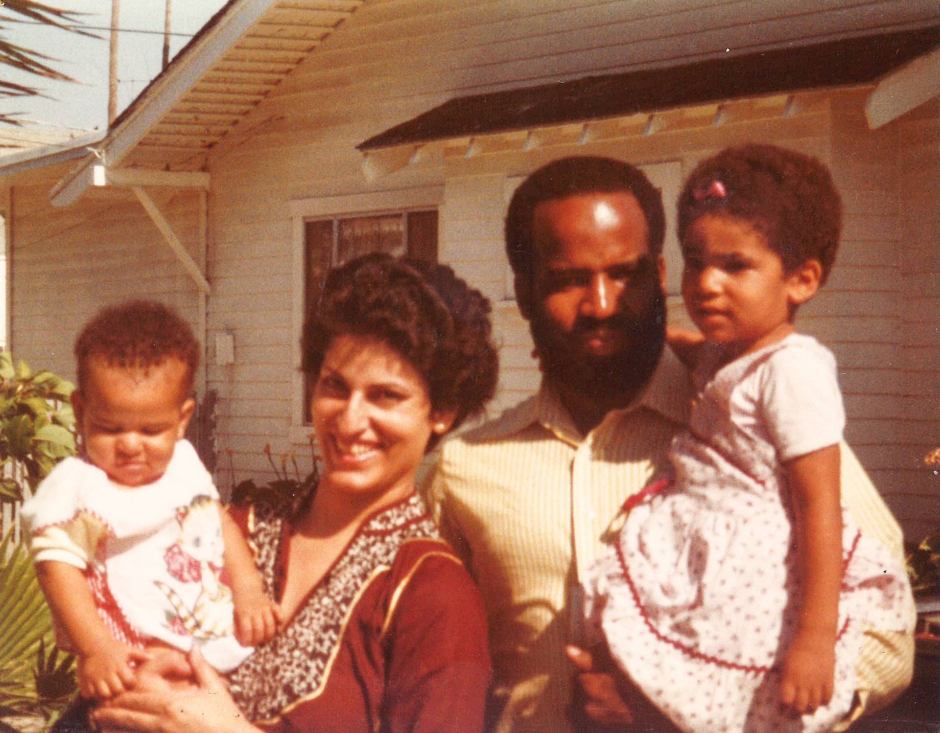 Ruha Benjamin as a young child with parents and sibling