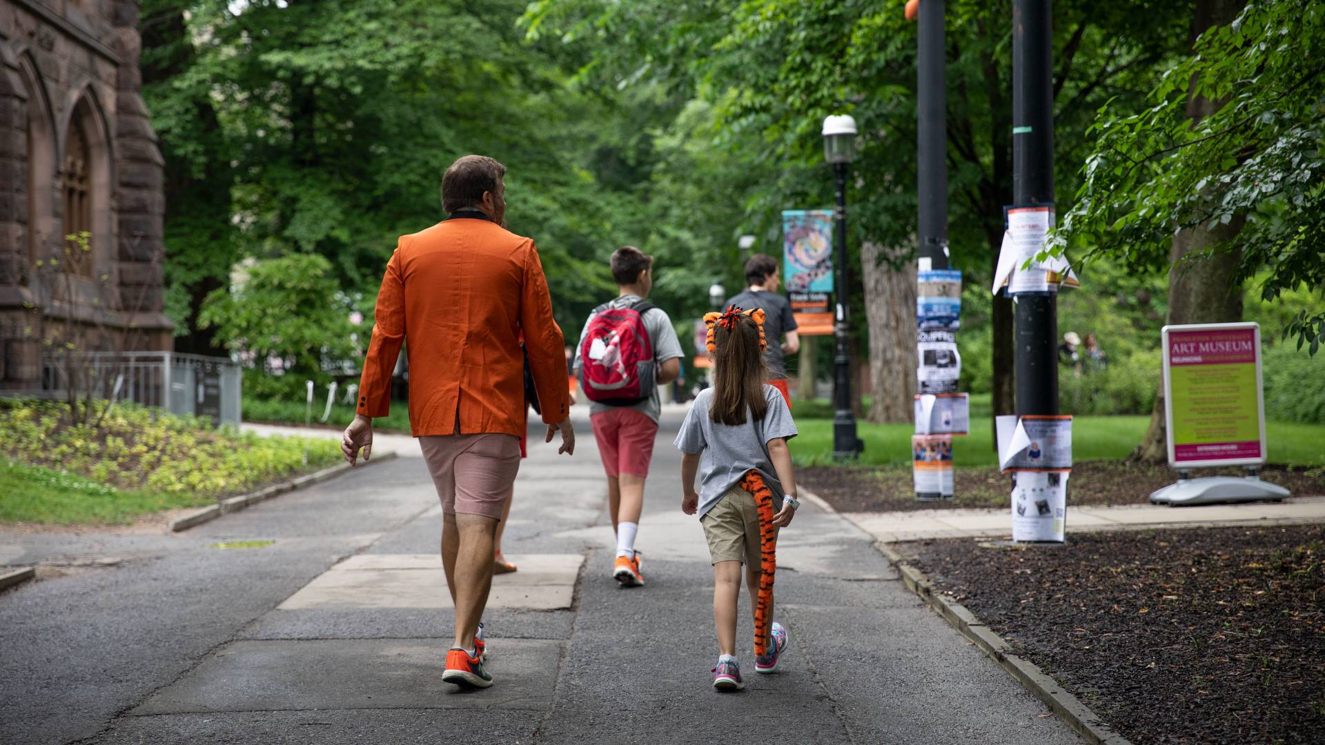 Family walking on campus during reunions