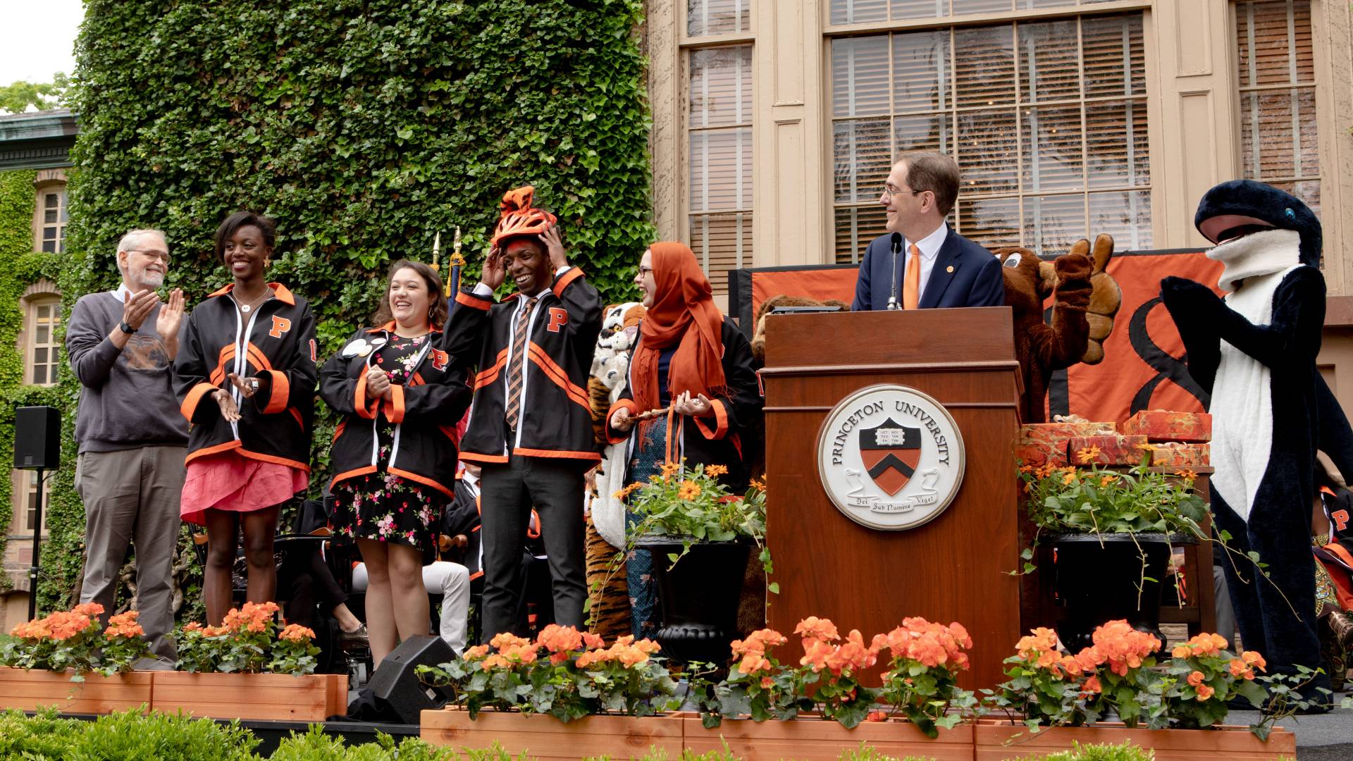 President Eisgruber on stage with students, mascots and professor Kernighan during Class Day ceremony