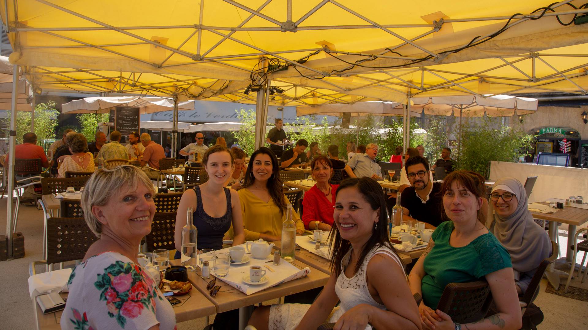 Faculty and graduate students sitting in outdoor cafe in France